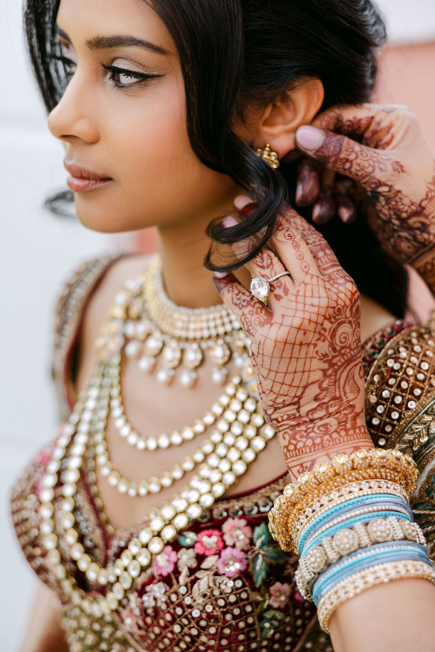 Close-up details of traditional Indian wedding jewelry and bangles.