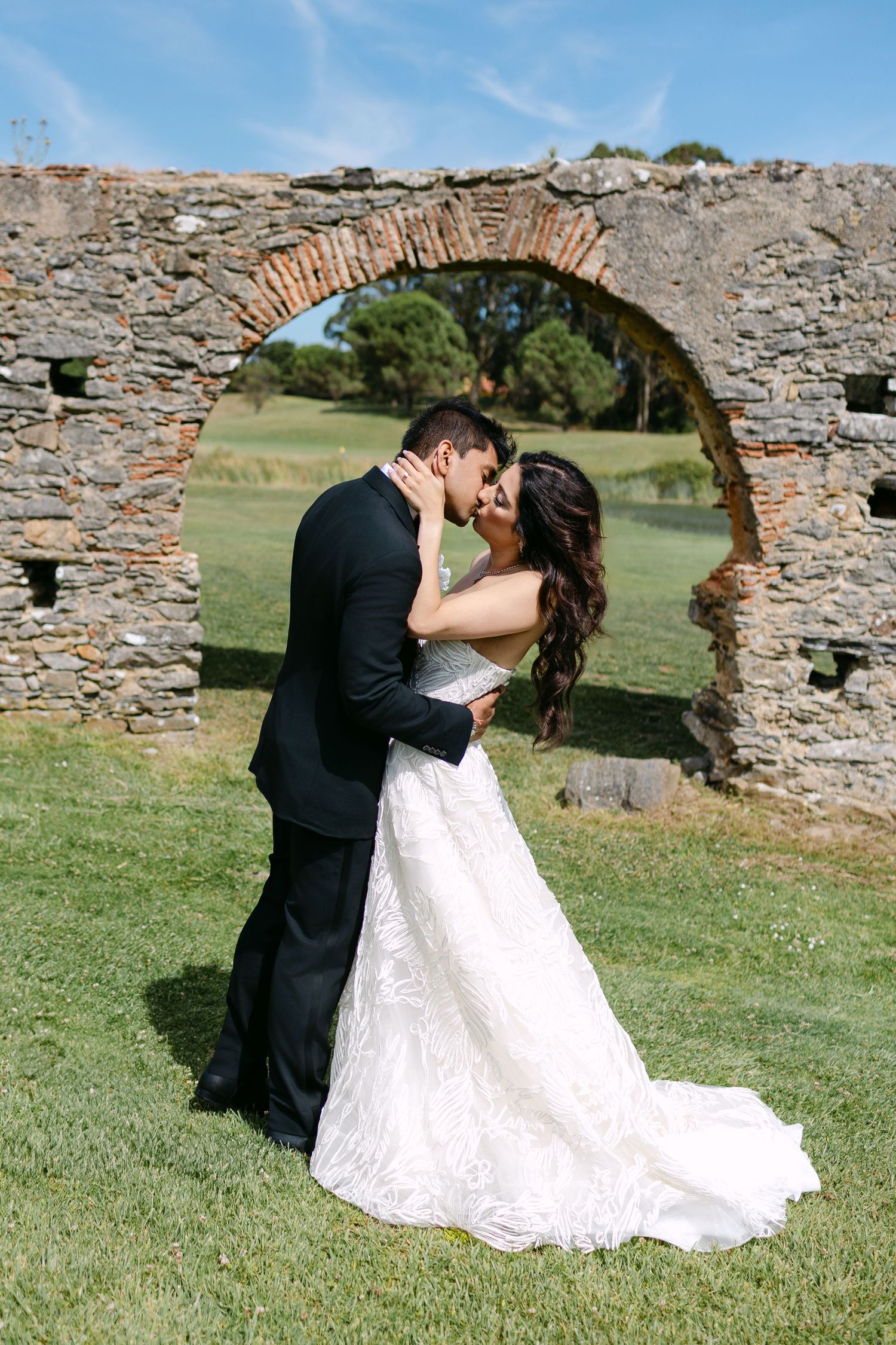 Romantic wedding sequence showing couple dancing and embracing by ancient stone ruins.