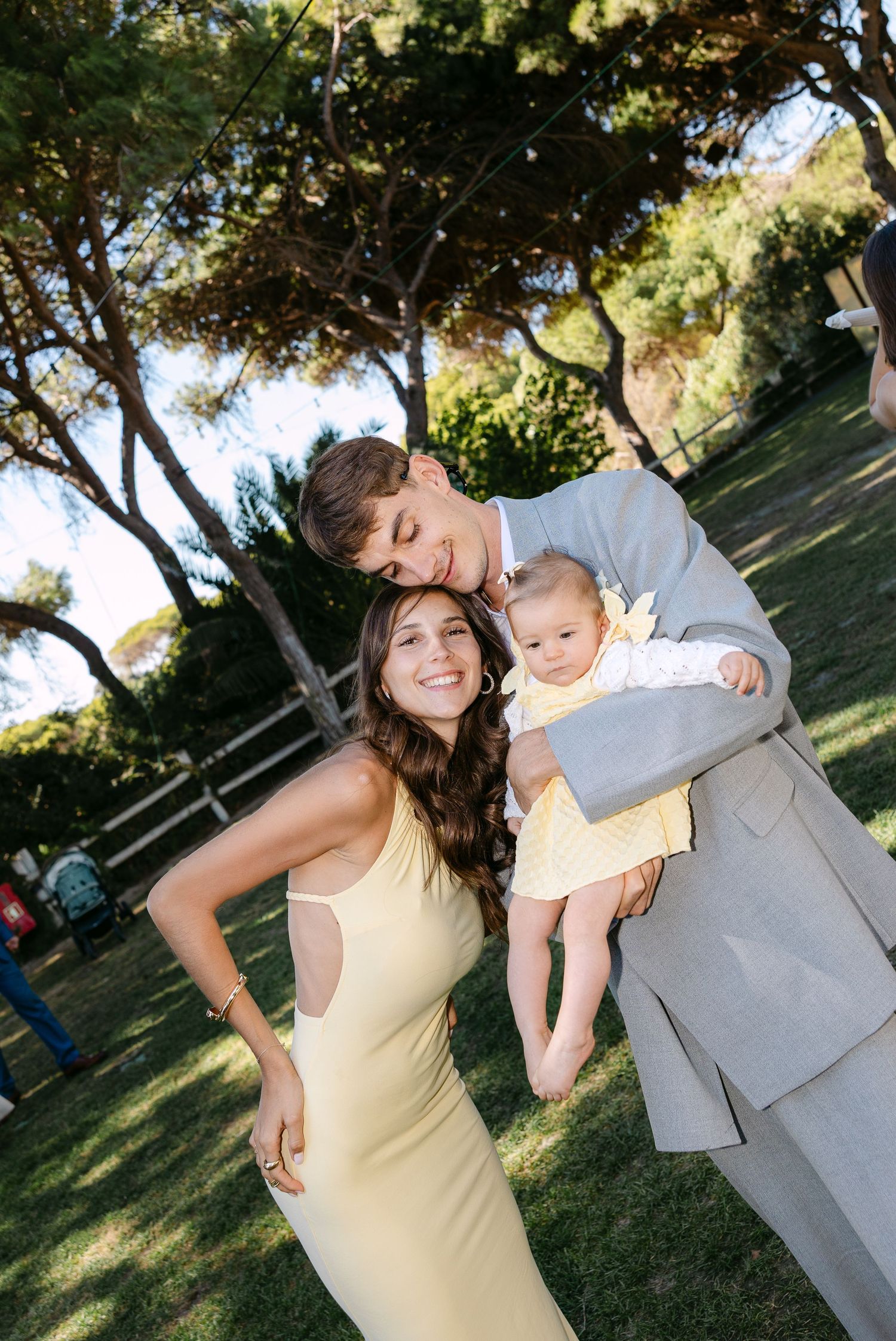 Candid wedding party moments captured in an outdoor garden setting.