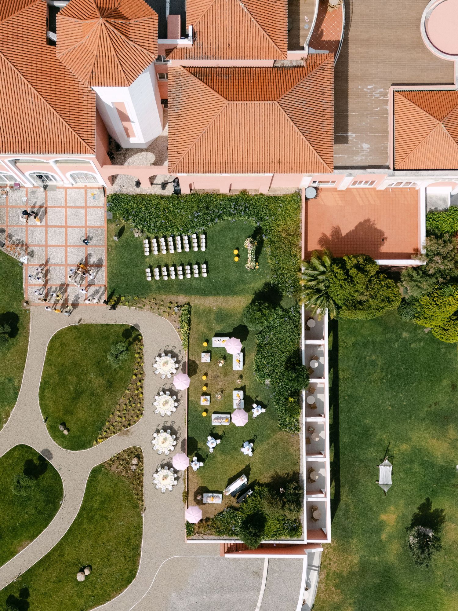 Bird's eye view of a luxury venue with manicured gardens and outdoor event spaces.
