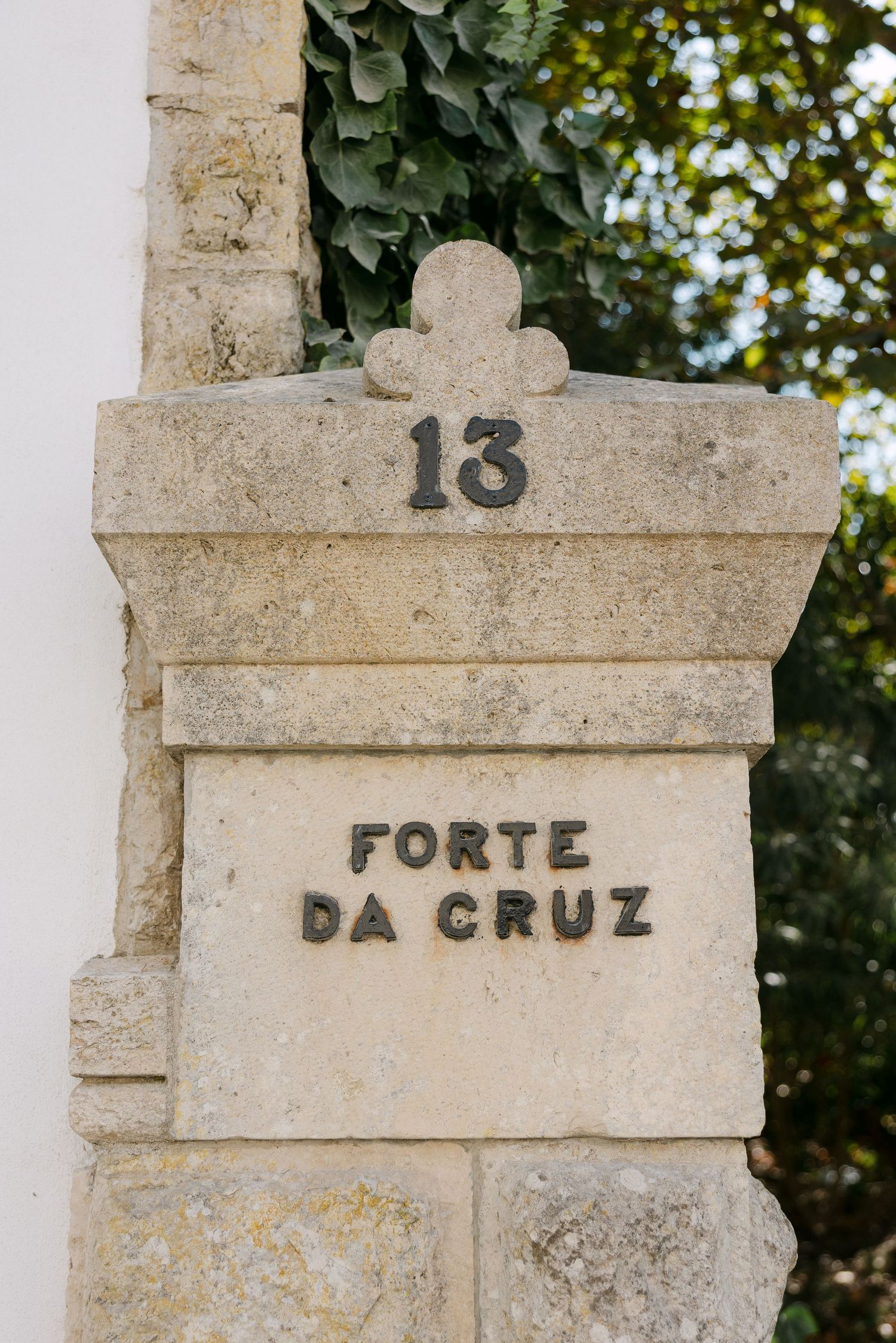 Stone pillar marked with number 13 and text reading 'Forte da Cruz'.