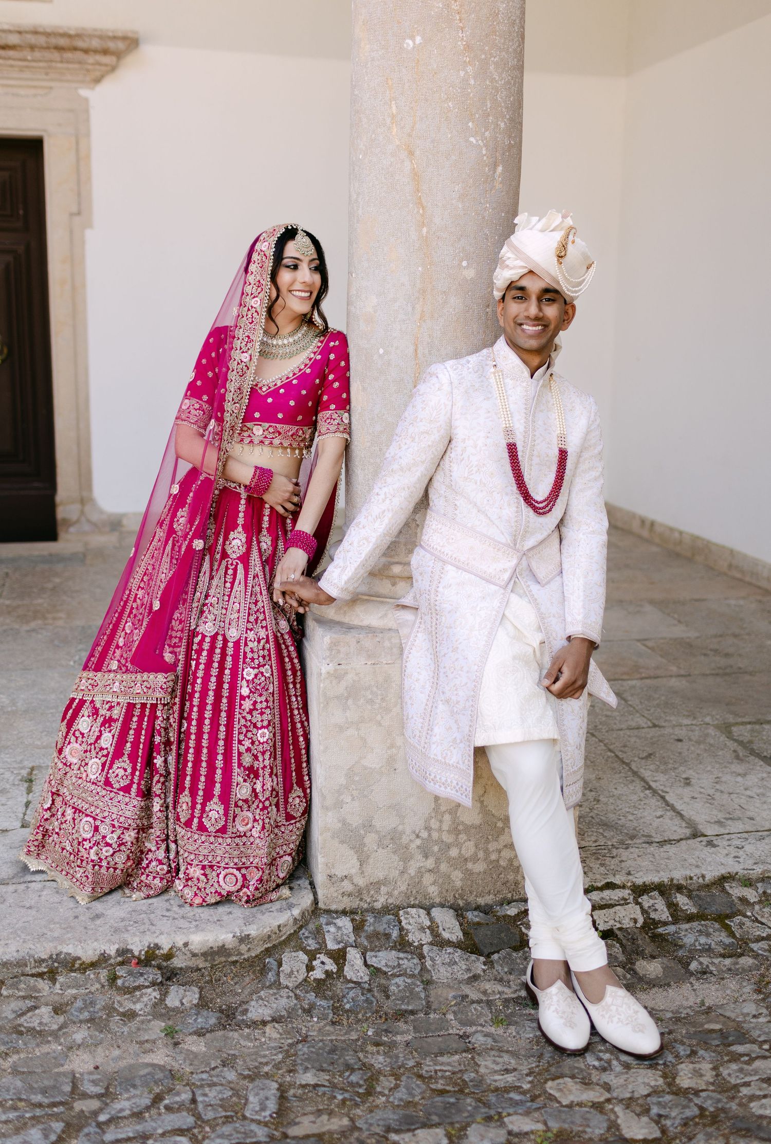 Wedding couple in traditional Indian attire photographed in various poses against stone architecture.