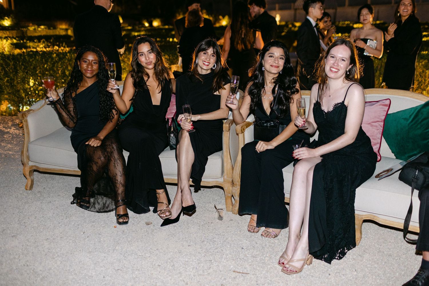 Guests seated at formal dinner tables in an elegant event setting.