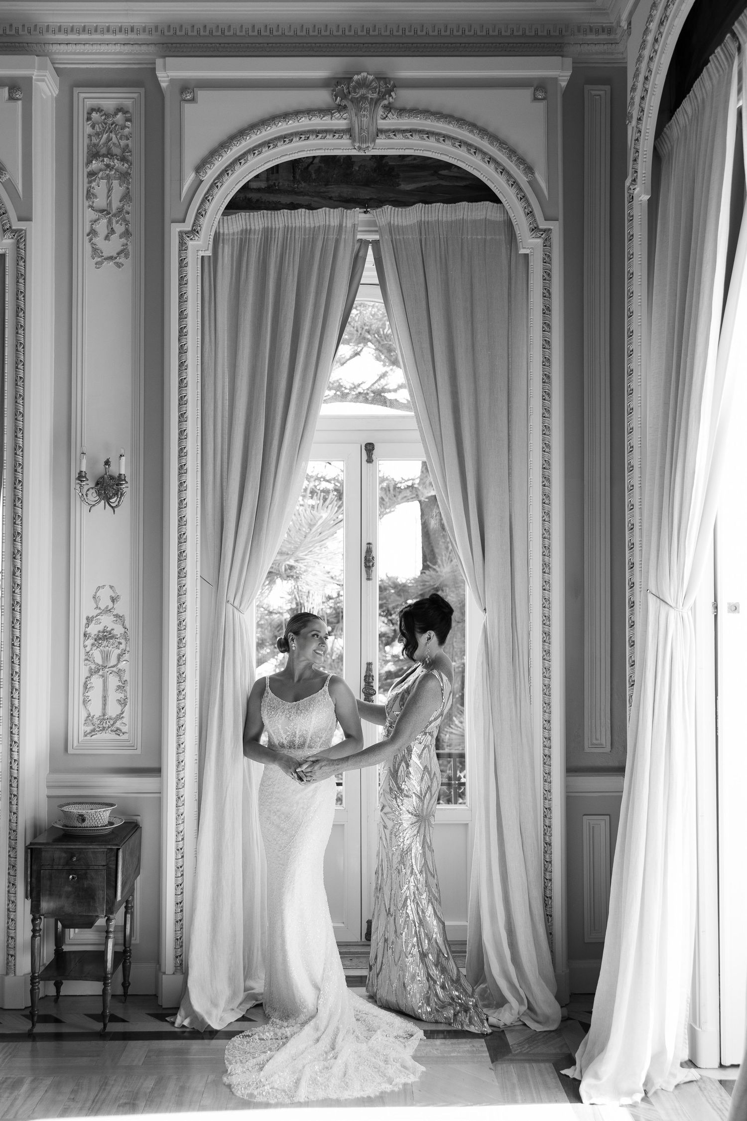 Black and white photos showing elegant interior scenes with flowing curtains and ornate moldings.