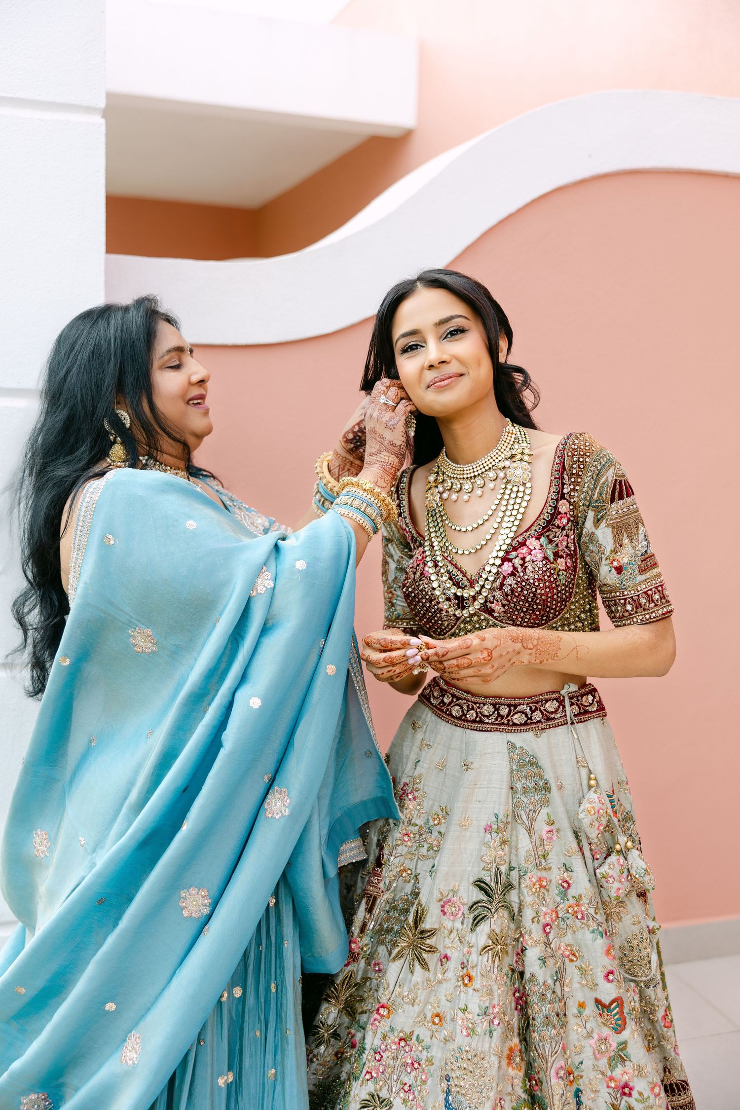 Traditional Indian wedding attire featuring an embroidered lehenga and turquoise dupatta.