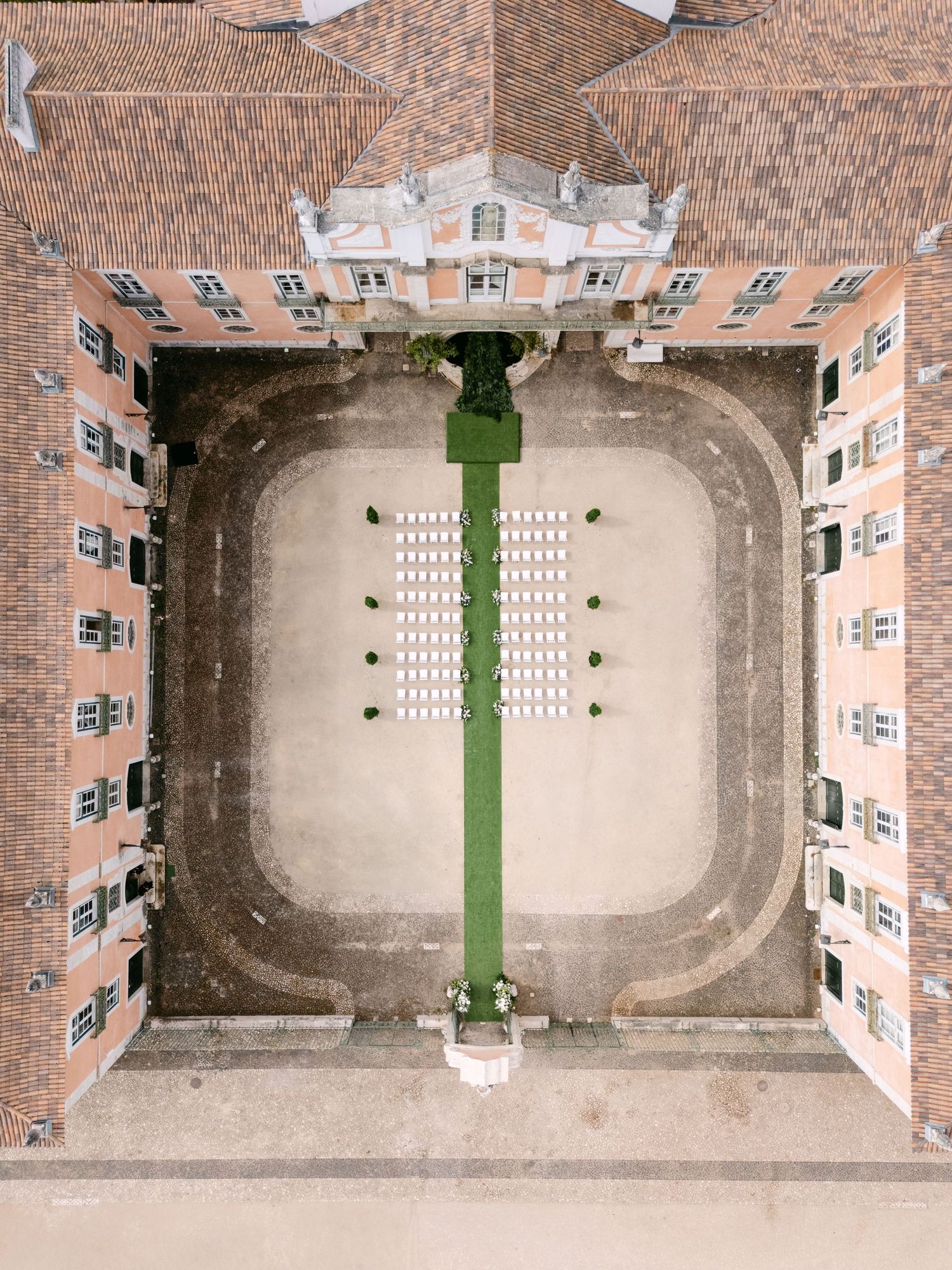 Bird's eye view of a historic palace courtyard featuring geometric patterns and landscaping.
