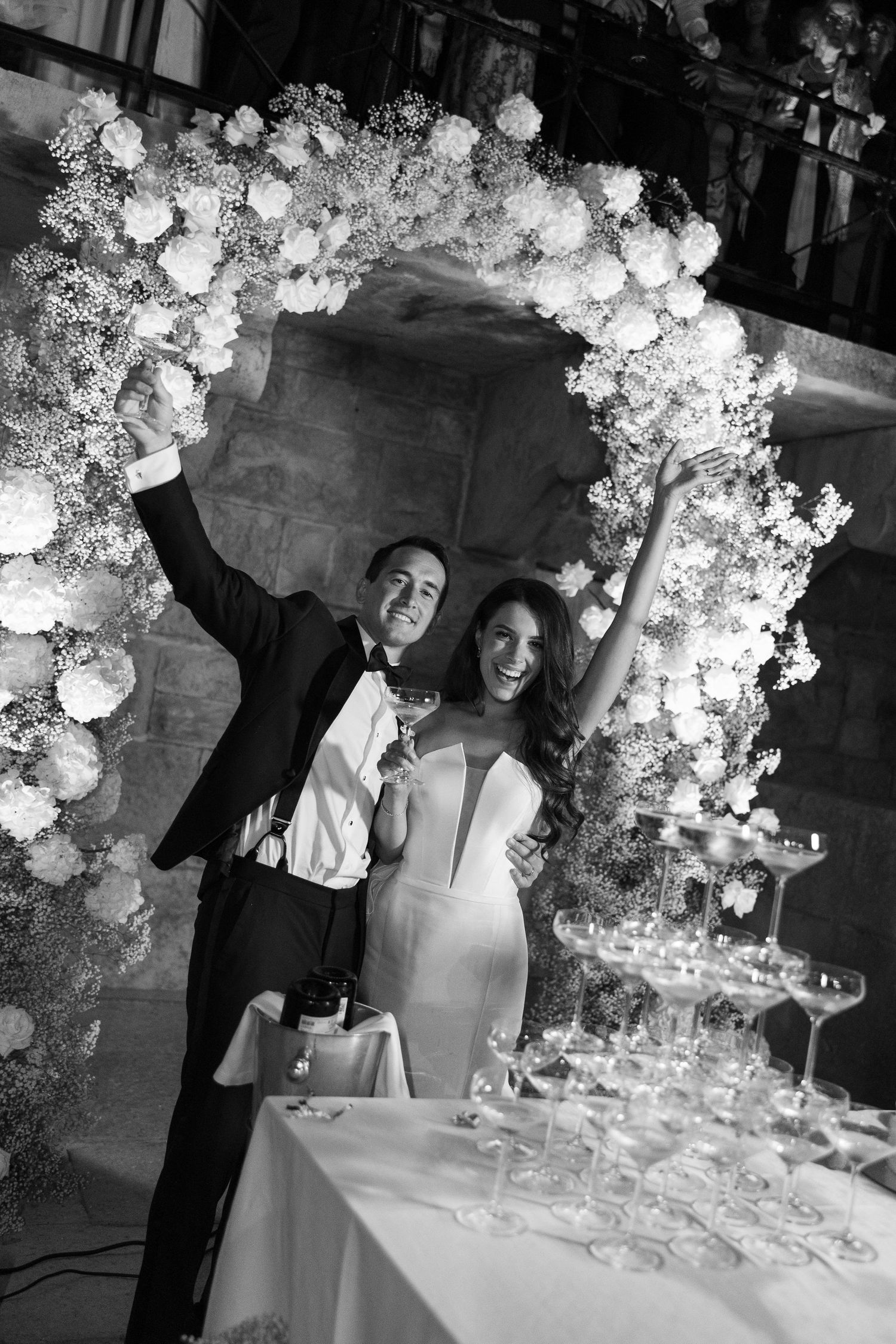 Elegant wedding reception setup with white floral arrangements and decorative elements.
