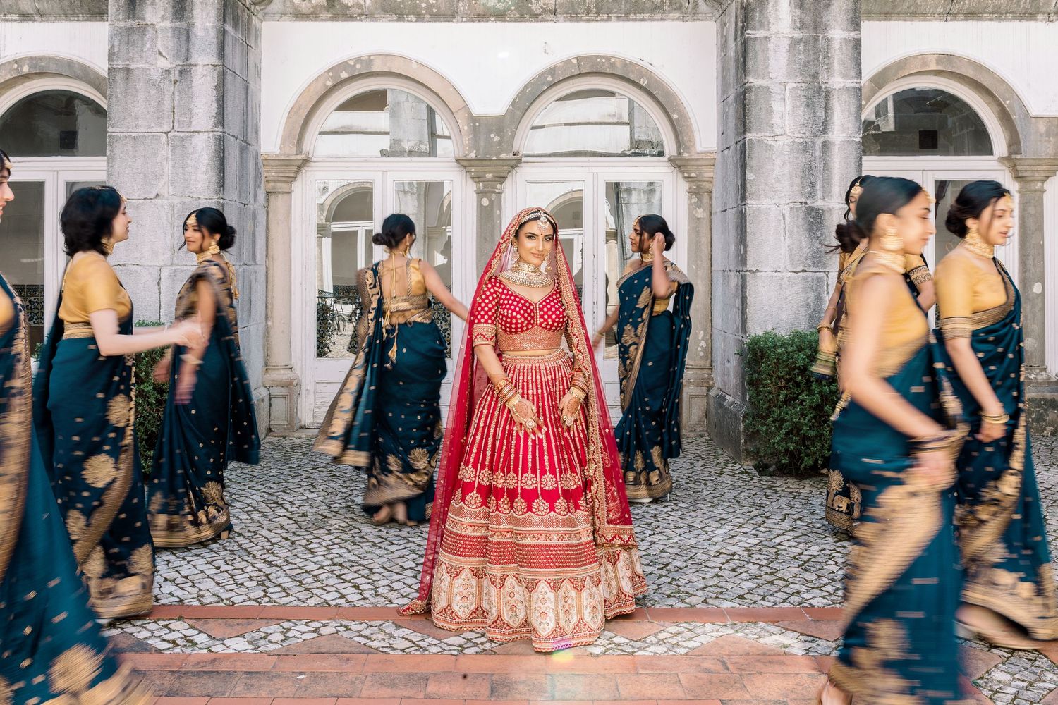 A traditional Indian wedding scene with attendees in colorful formal attire.