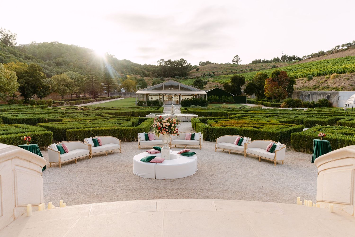 Panoramic view of a luxurious estate garden with manicured lawns and outdoor seating areas.