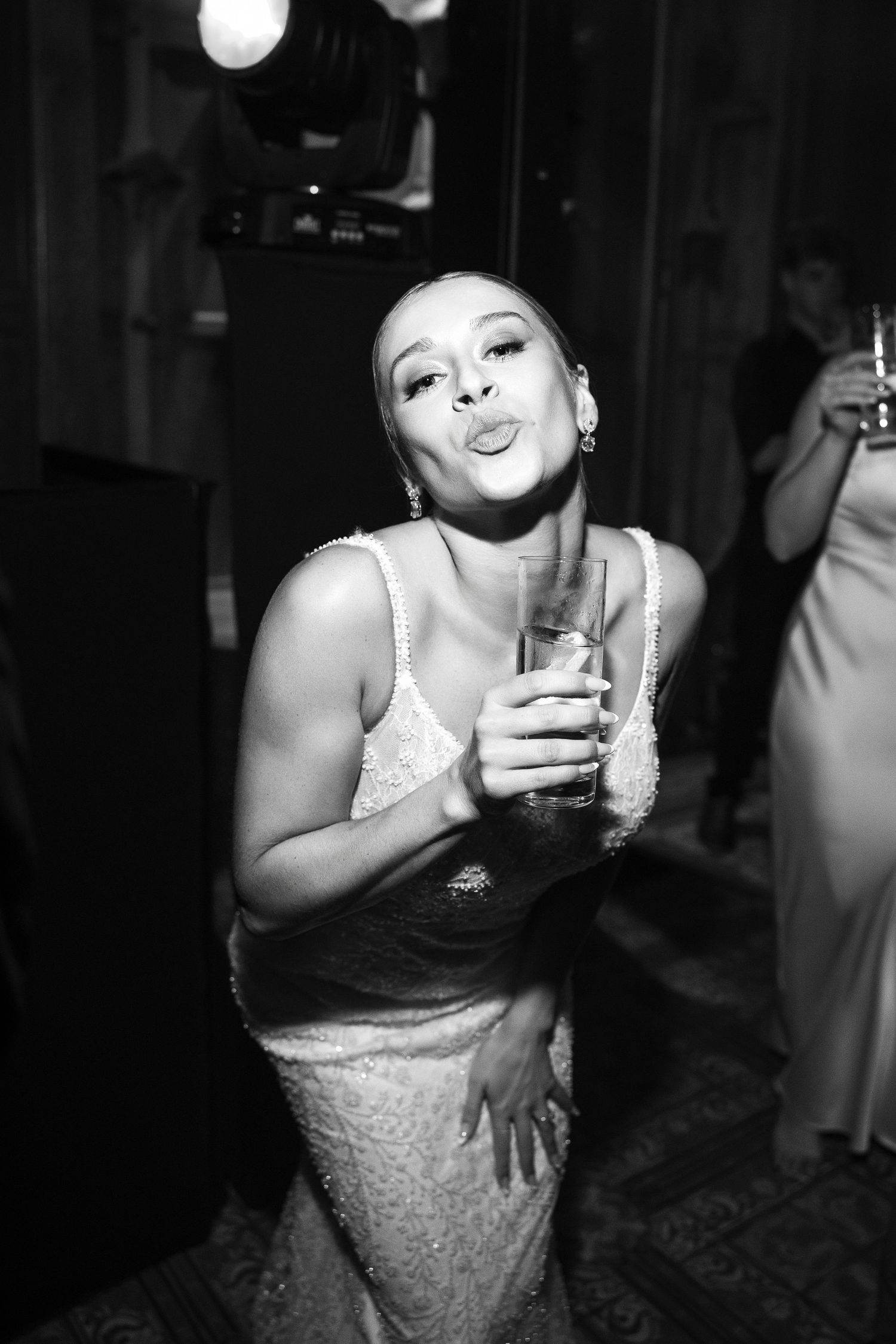 Black and white photos show a person in a white dress enjoying drinks at a celebration.