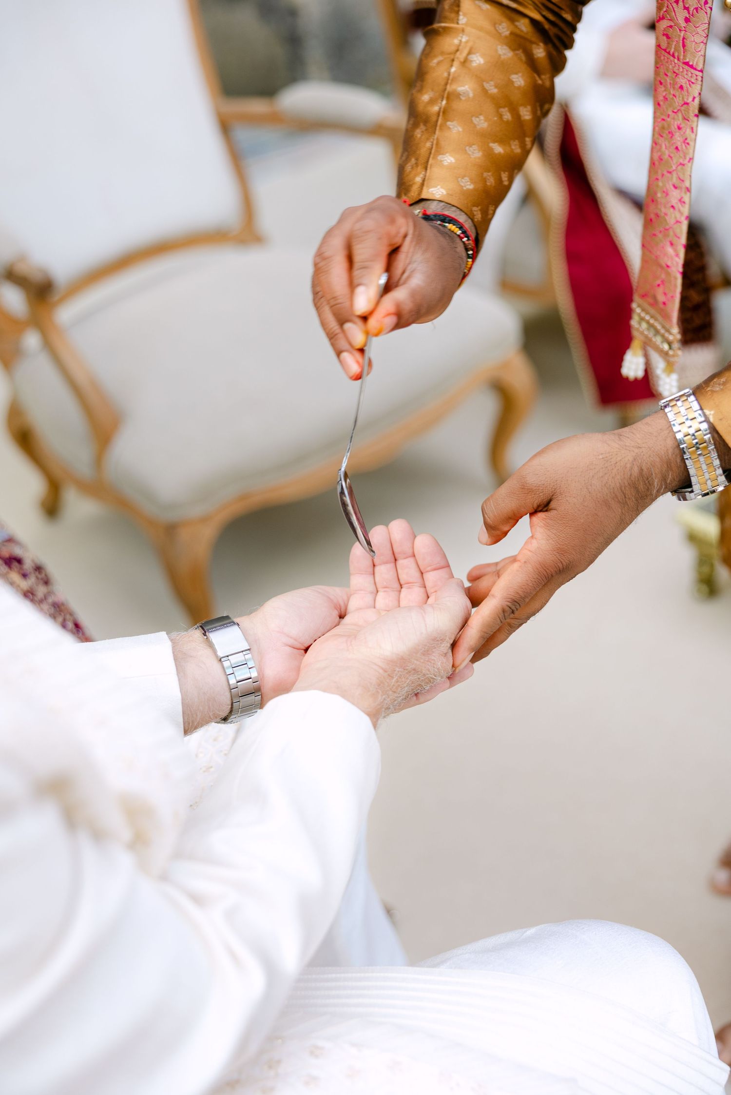 Close-up shots of hands adjusting formal white clothing and accessories.