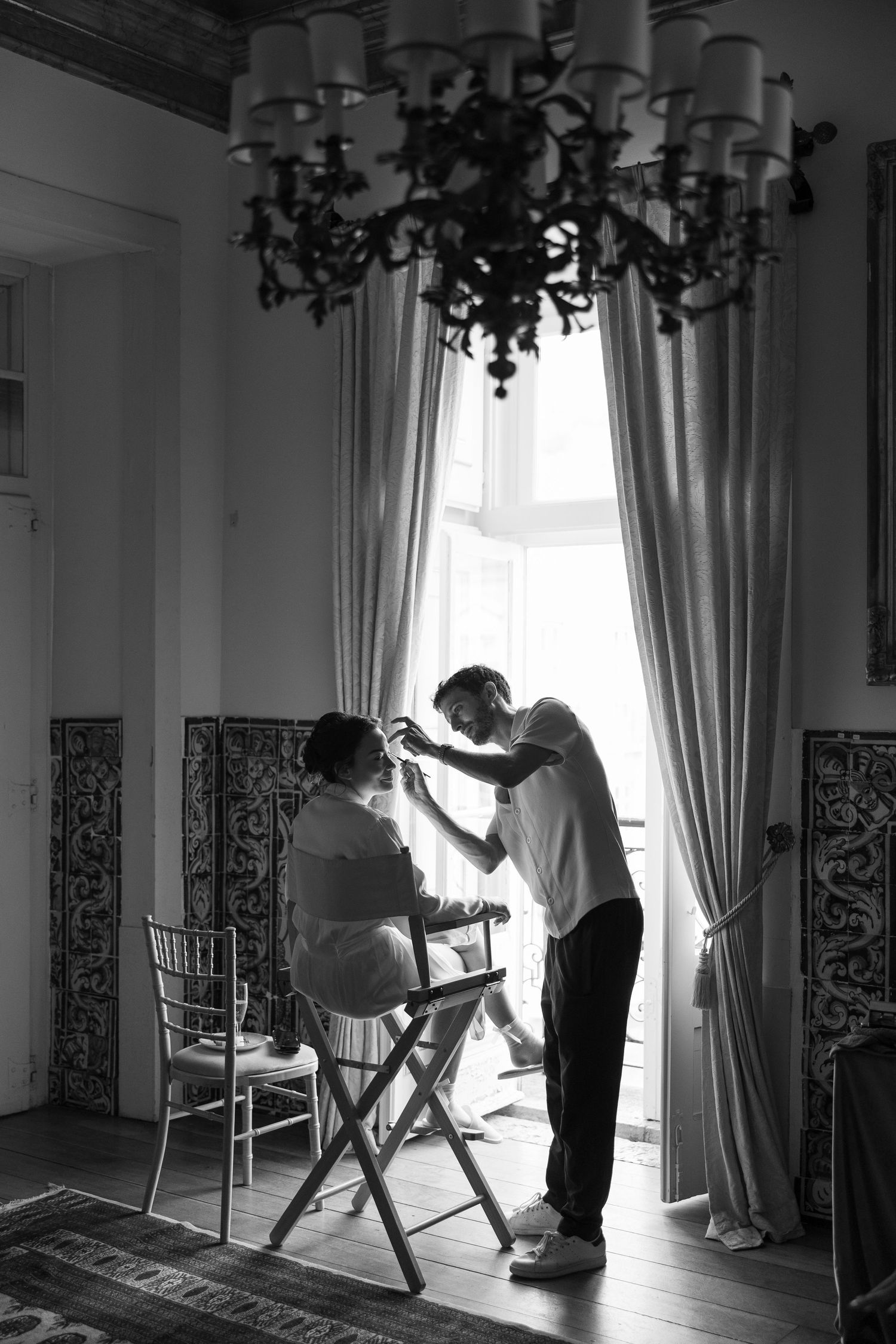 Black and white photos showing morning light streaming through curtained windows in an elegant room.