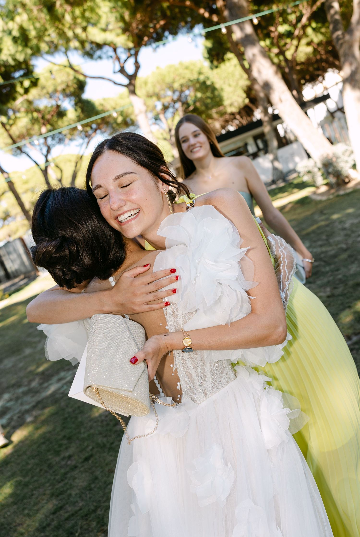 Emotional moments of wedding guests embracing and celebrating outdoors.