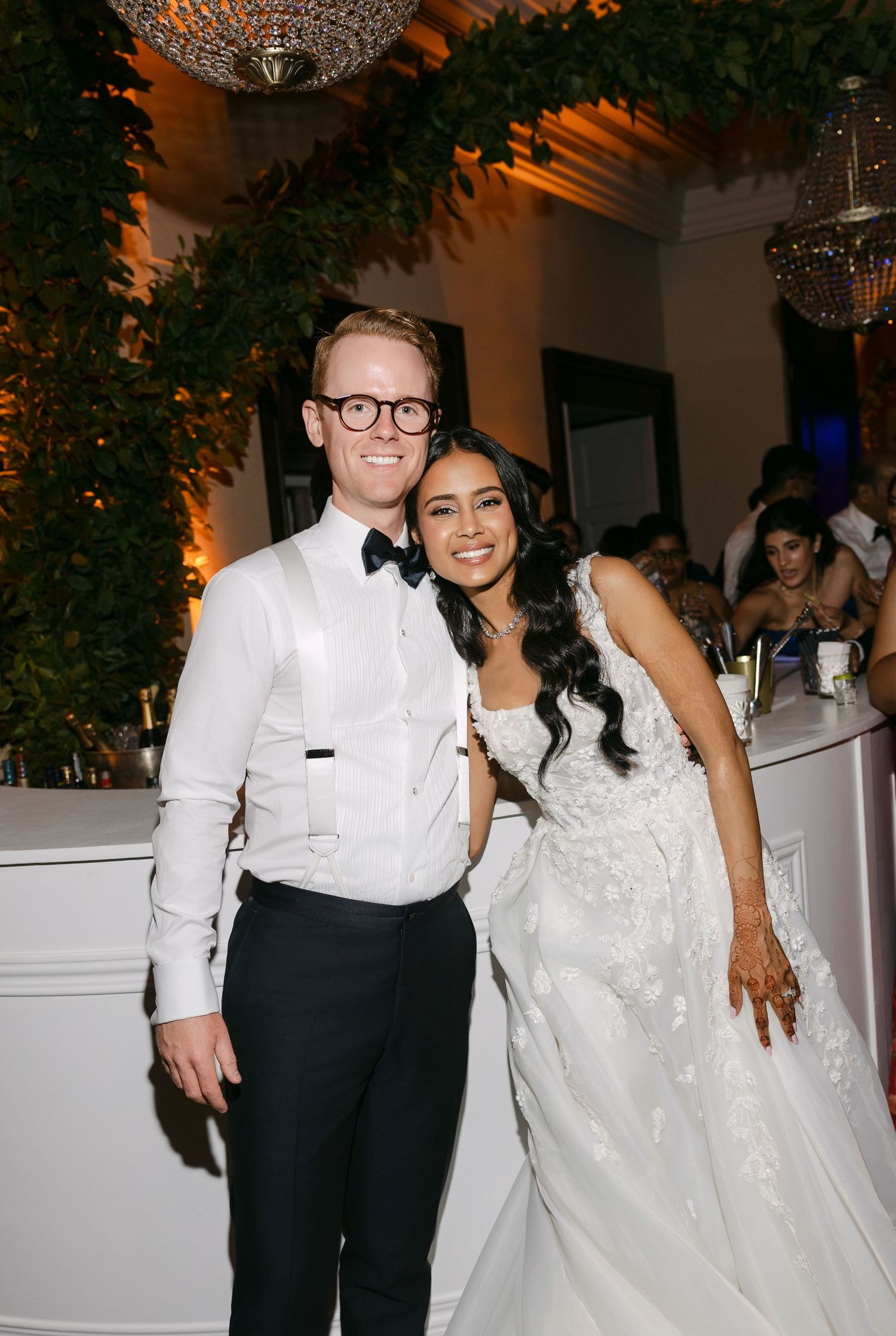Newlyweds sharing a joyful dance moment in their wedding attire.