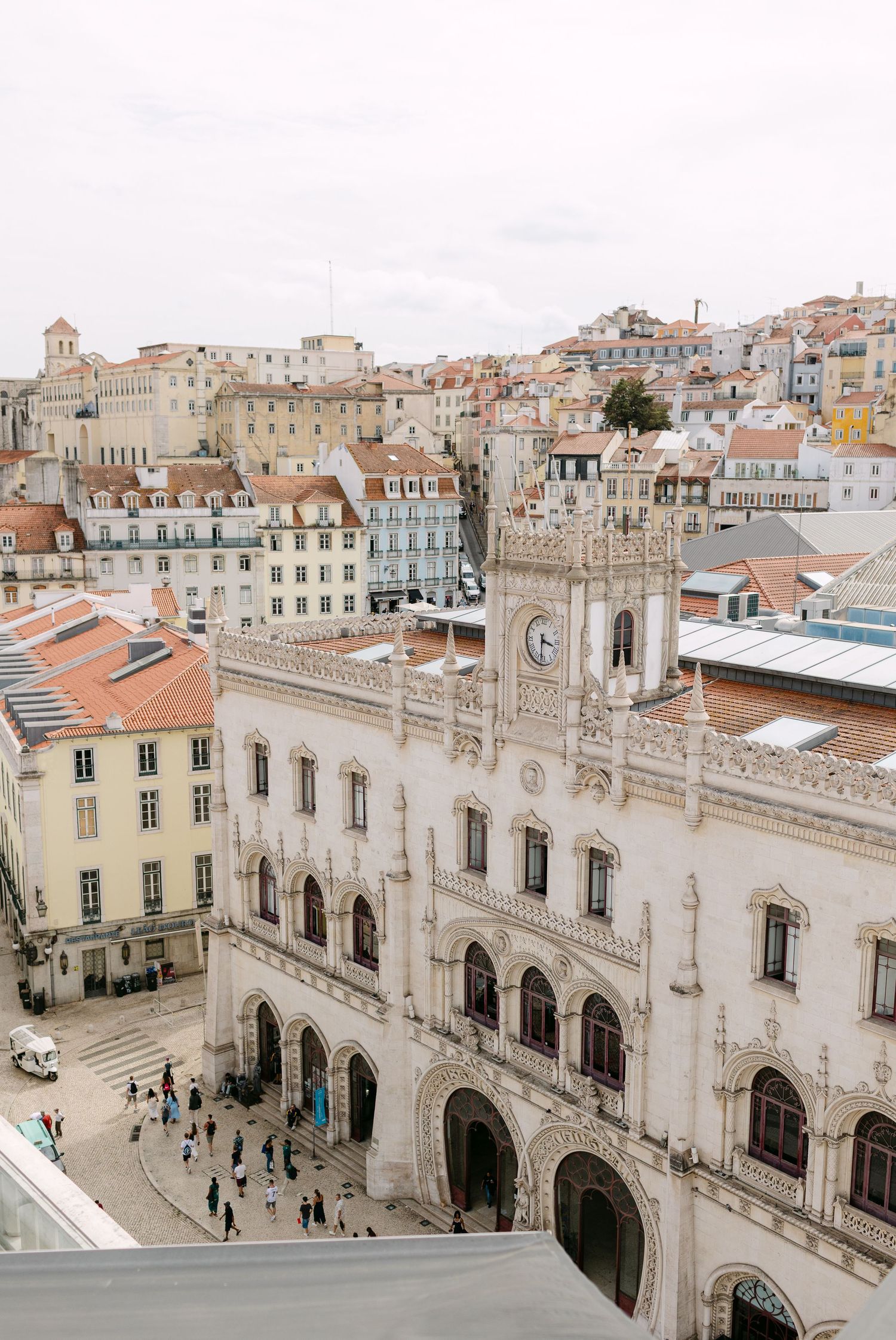 Panoramic view of historic Portuguese architecture with ornate Gothic details and clock tower.