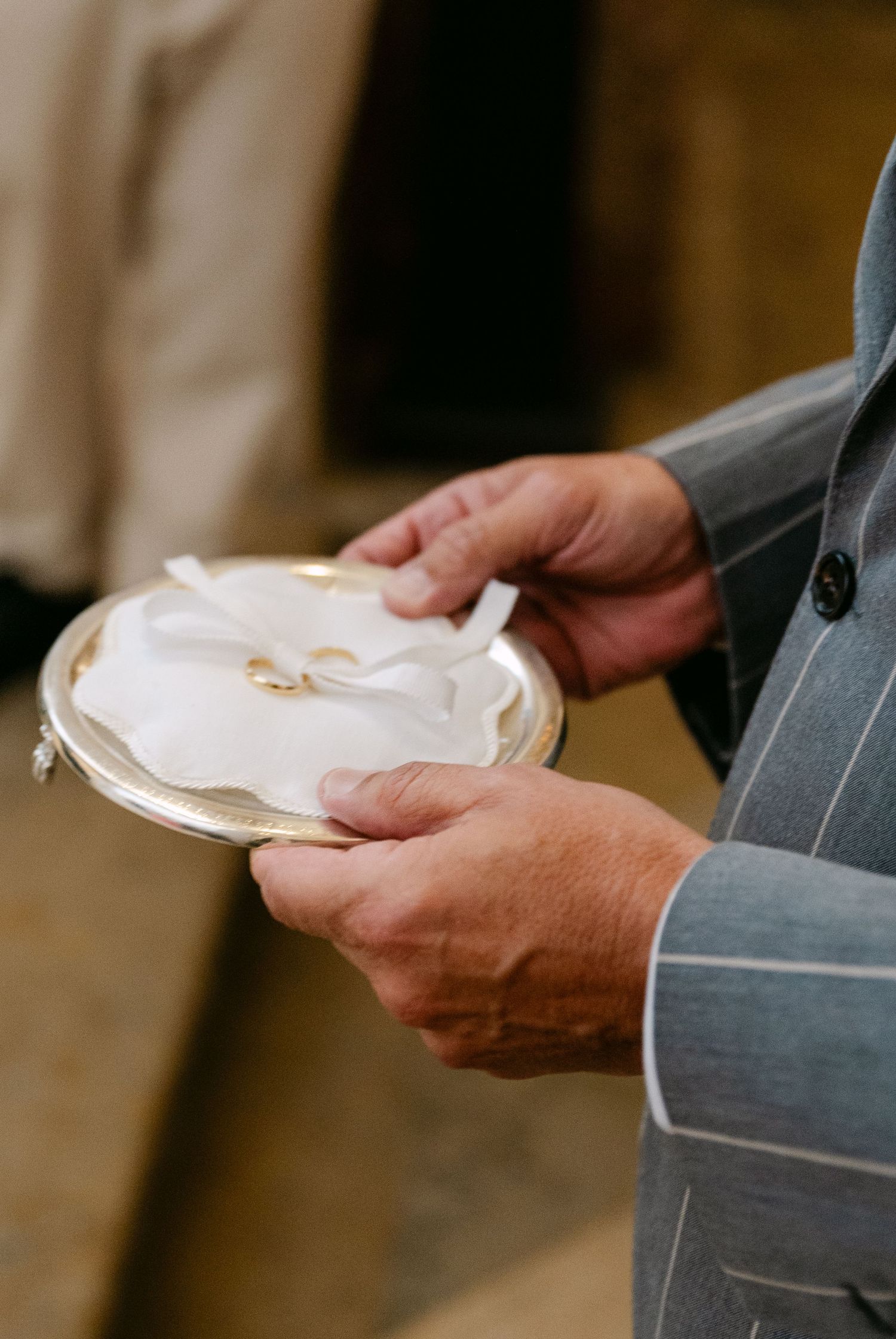 Wedding rings being held and displayed in a church during a ceremony.