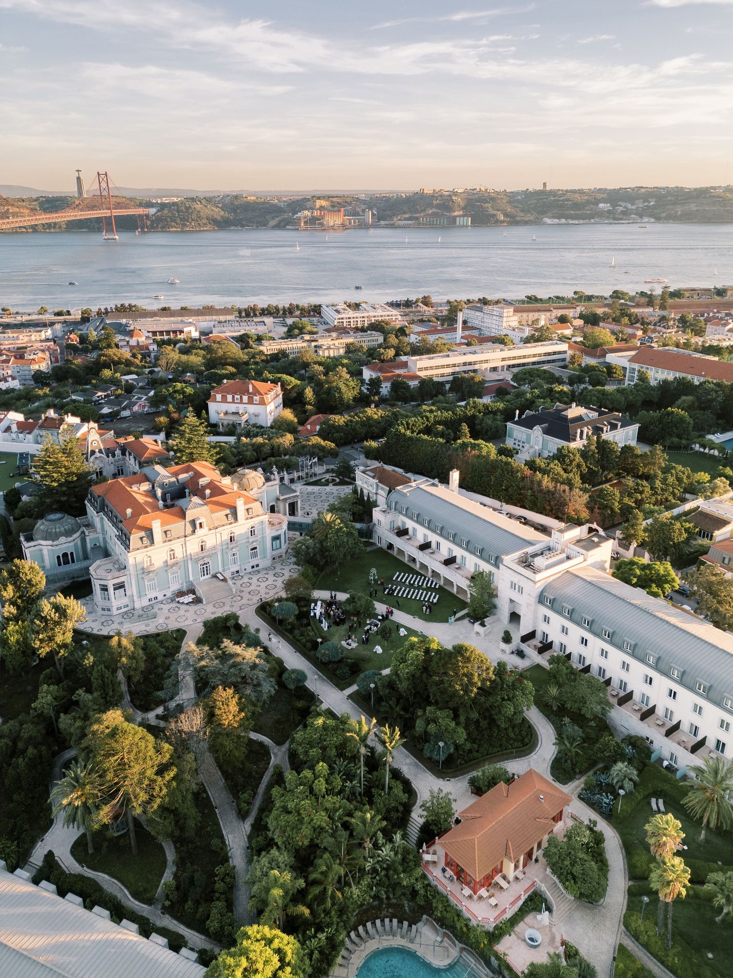 Aerial view of a coastal property with white buildings and landscaped grounds near the Golden Gate Bridge.