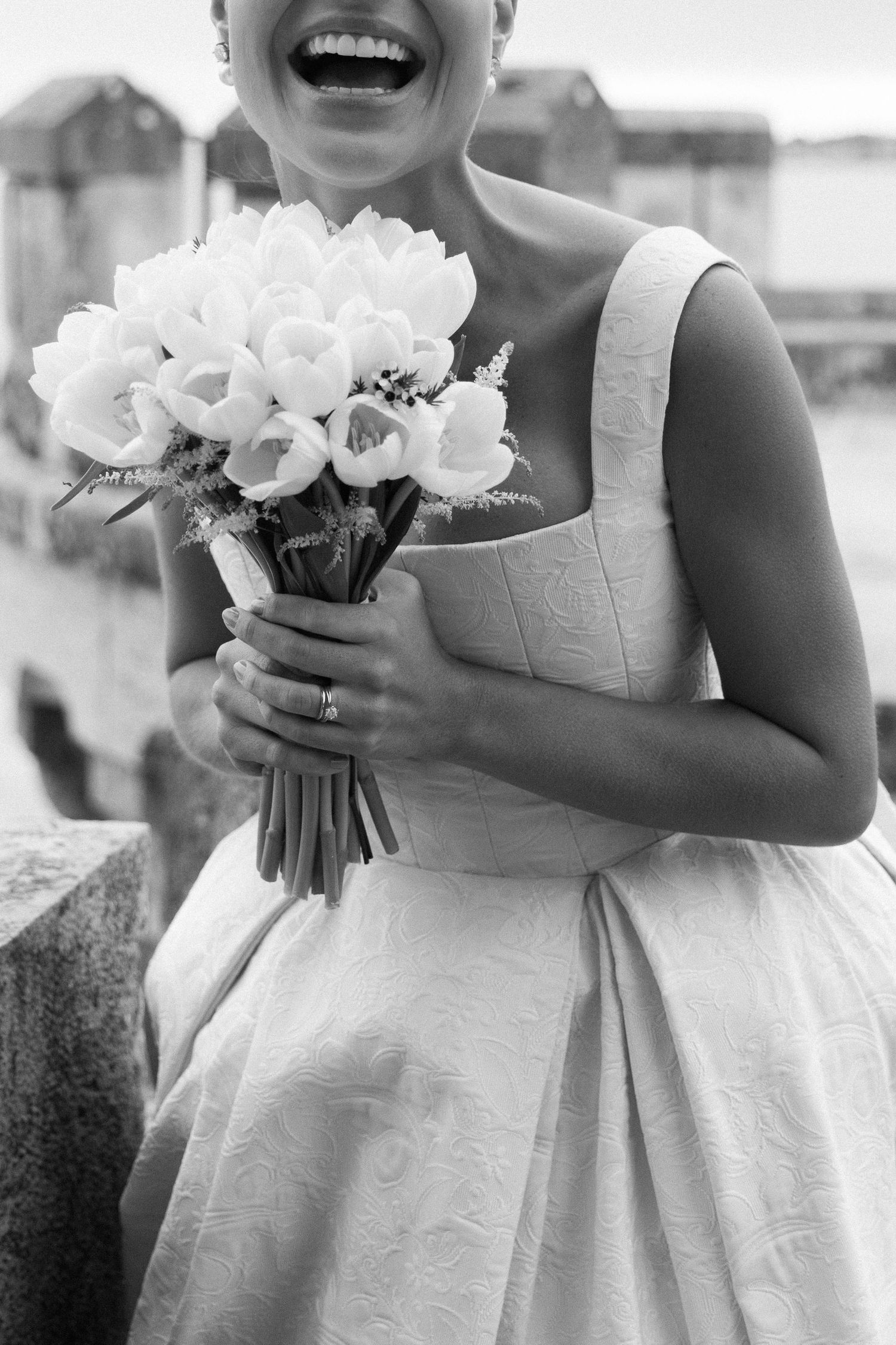 Flower girls in white dresses hold beautiful white bouquets.