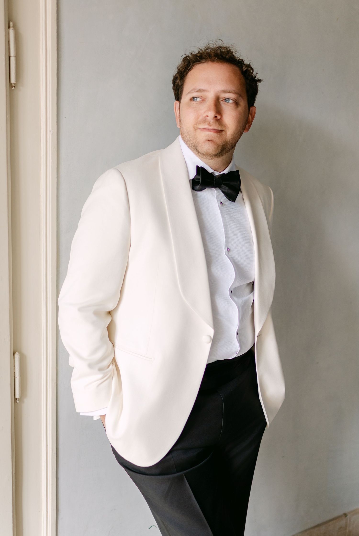 A series of portraits showing a person in a white dinner jacket and black bow tie.