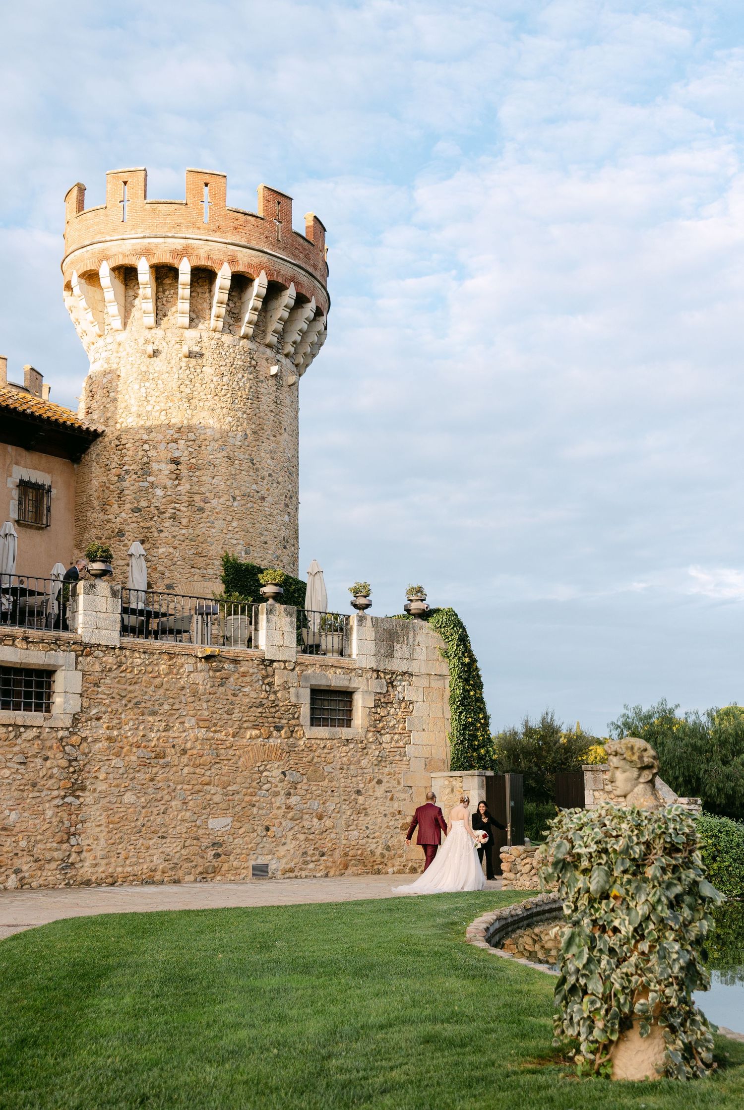 Medieval castle with stone towers and walls provides a stunning backdrop for a wedding celebration.