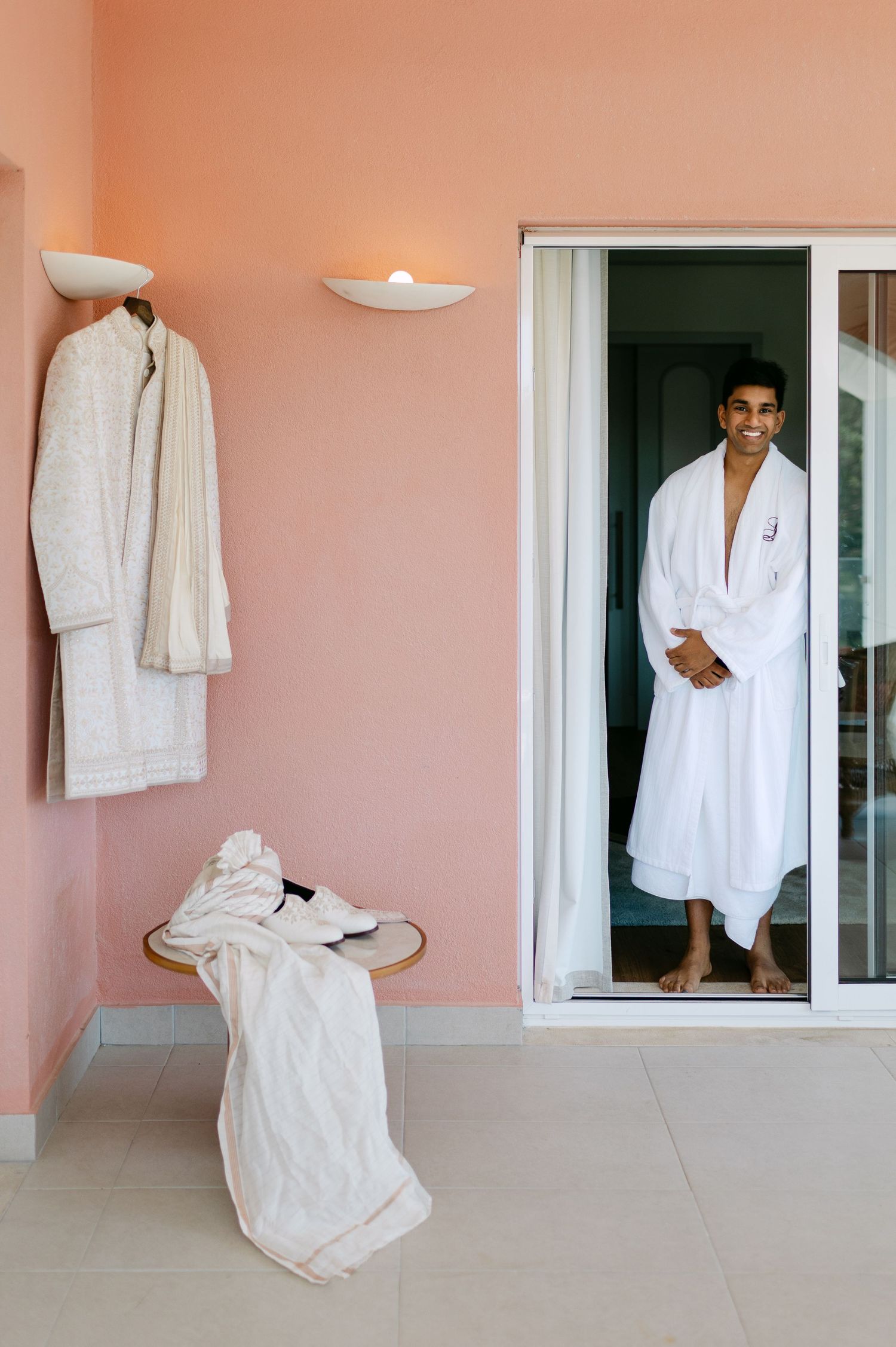 Getting ready sequence in pink-walled room with white bathrobes.