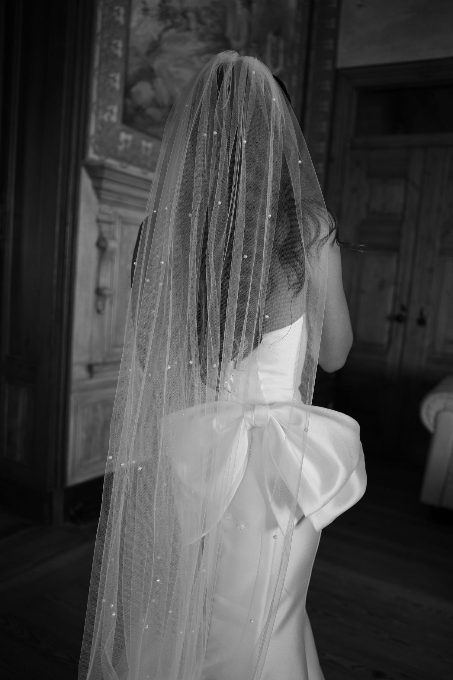 Close-up details of a pearl-studded wedding veil in dramatic black and white.