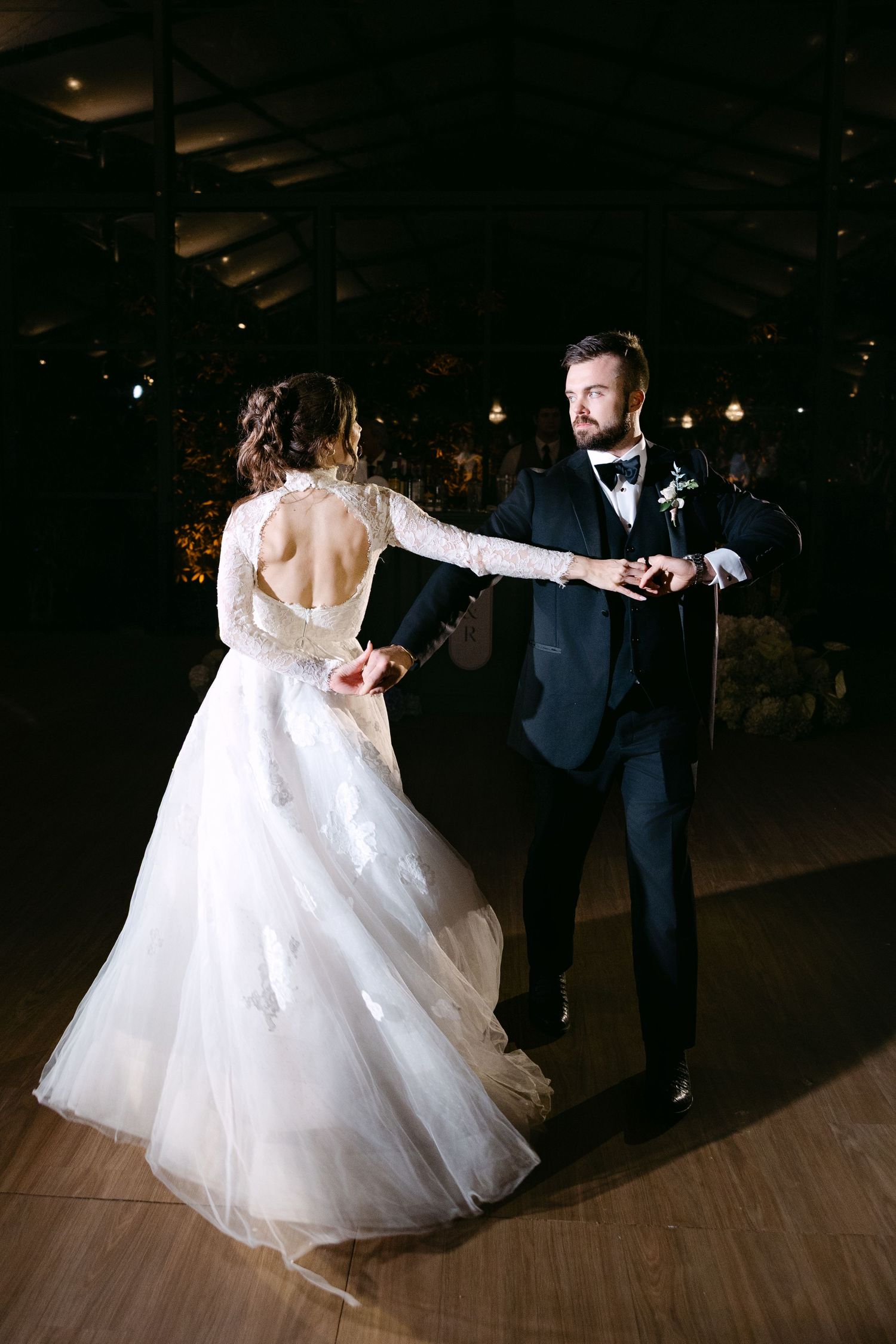 Sequence of a bride in a flowing white ballgown dancing with her partner at their wedding reception.