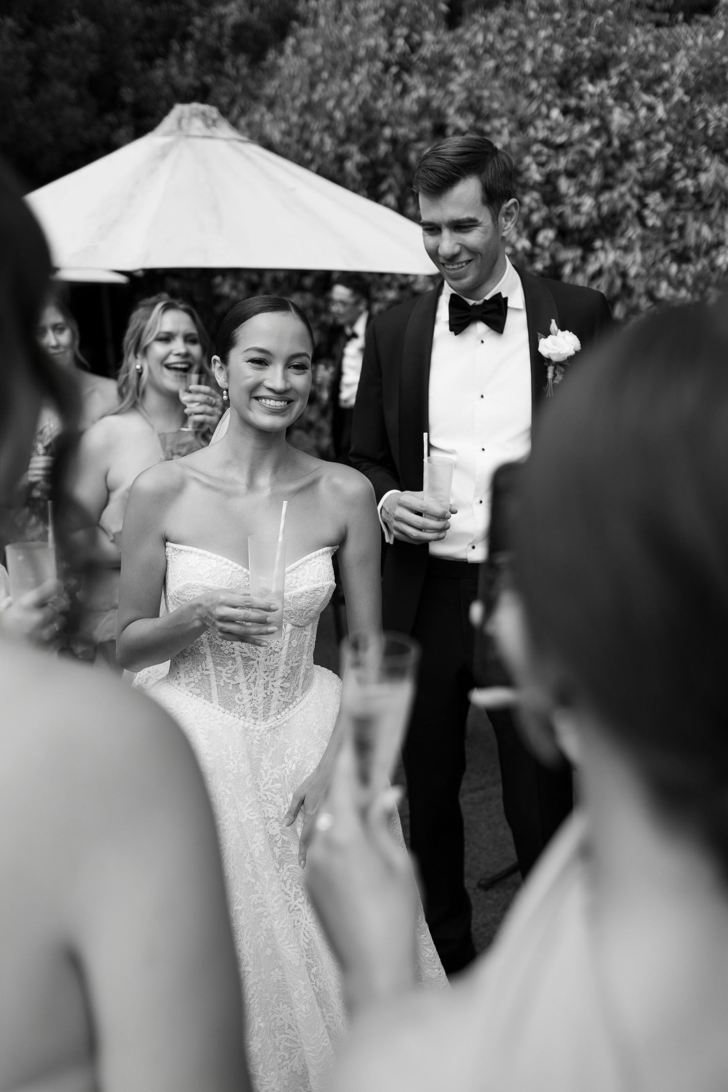 Black and white candid shots of wedding guests enjoying the celebration.