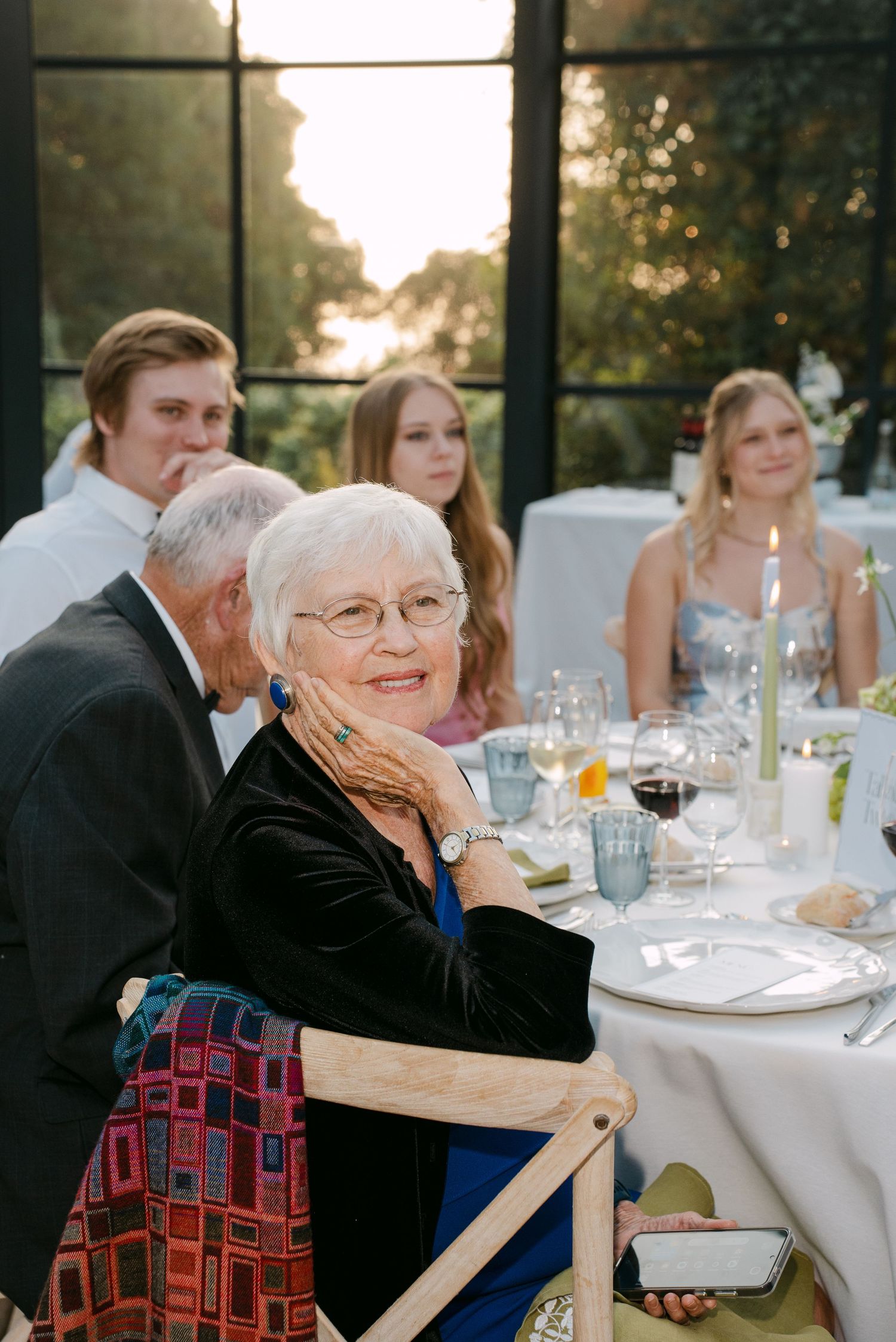 Wedding reception guests enjoying dinner at elegantly set tables.
