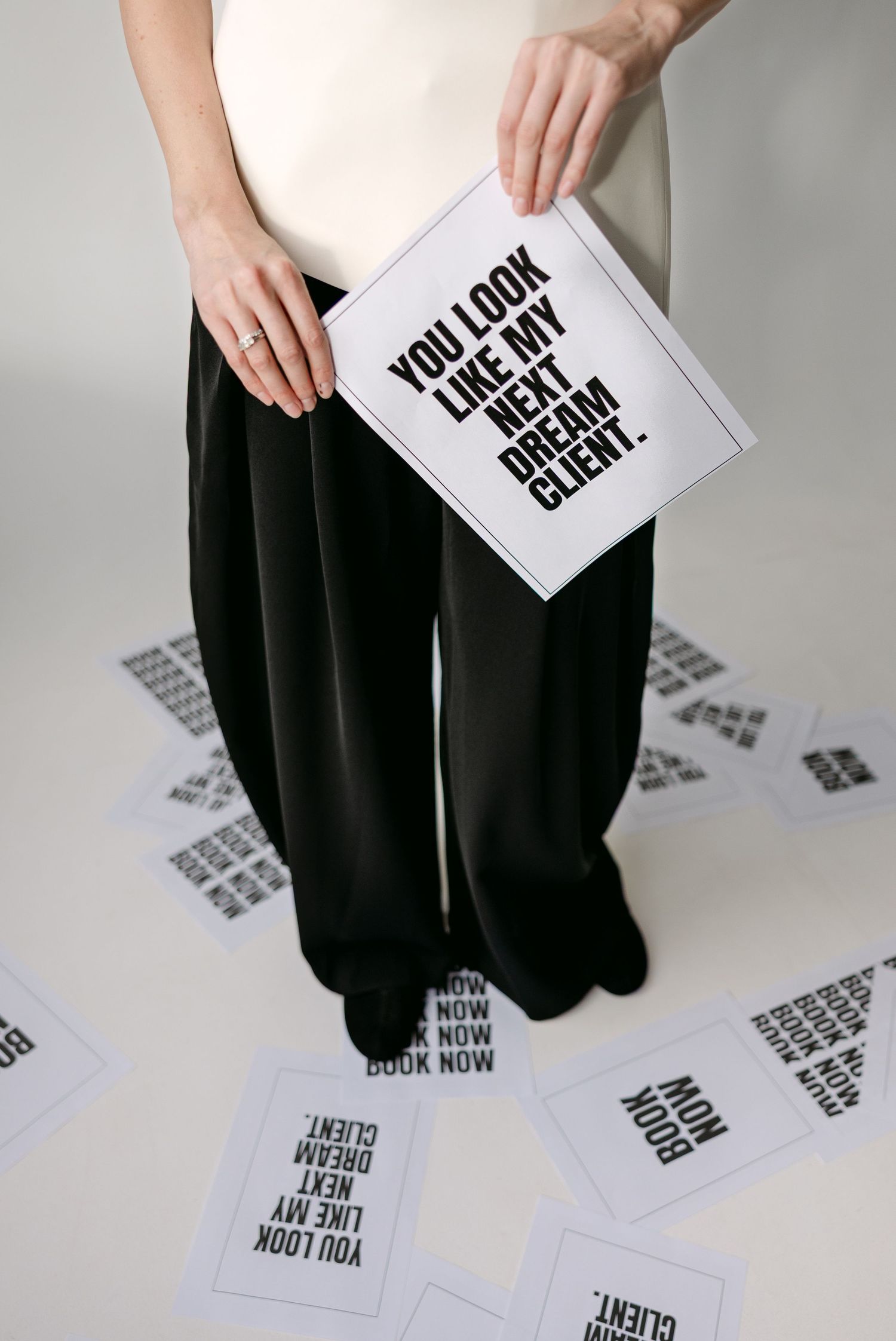 Minimalist black and white photo series featuring text cards and dark clothing against white background.