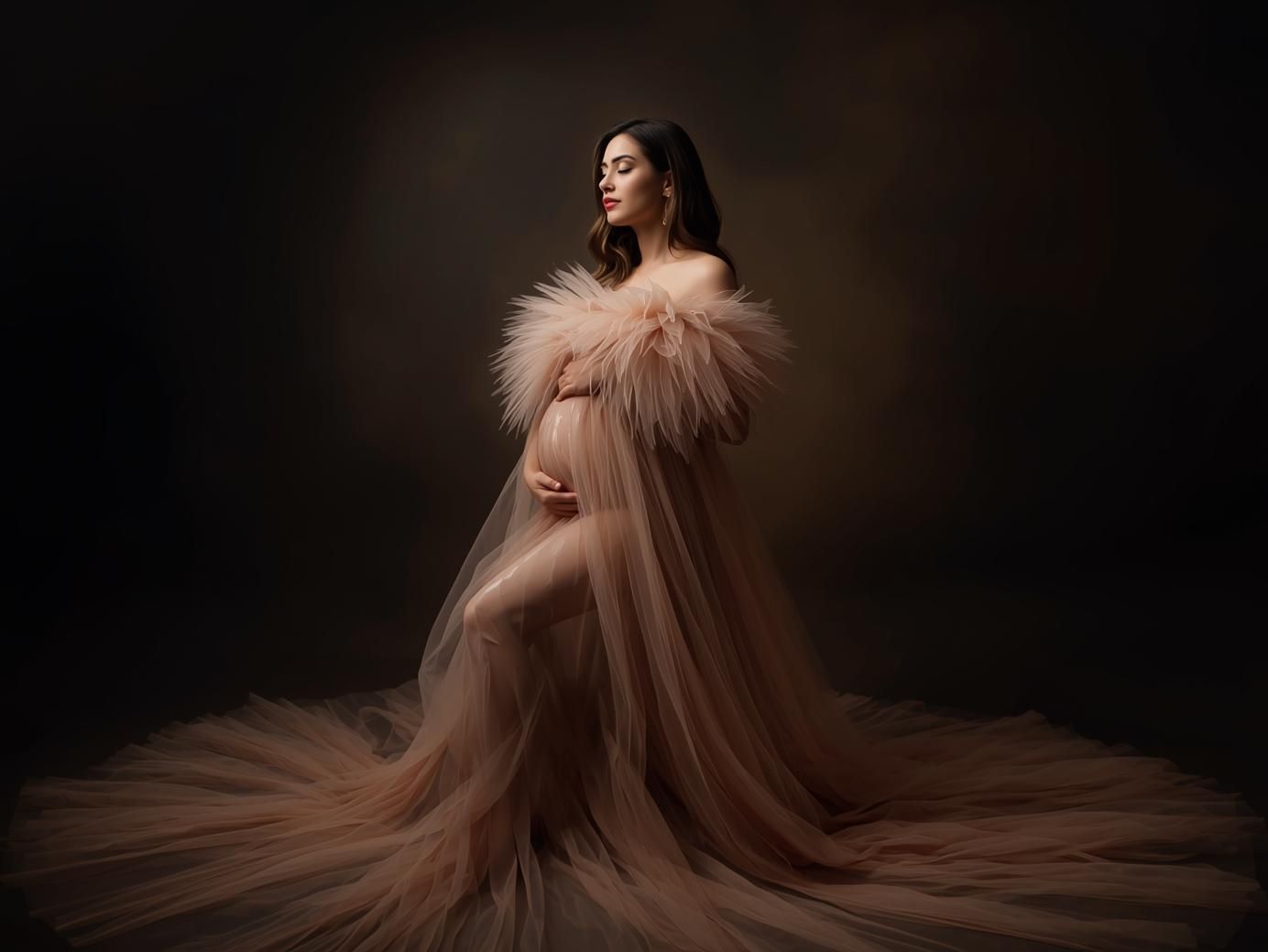 Artistic maternity portrait series with flowing fabric in dramatic dark lighting.