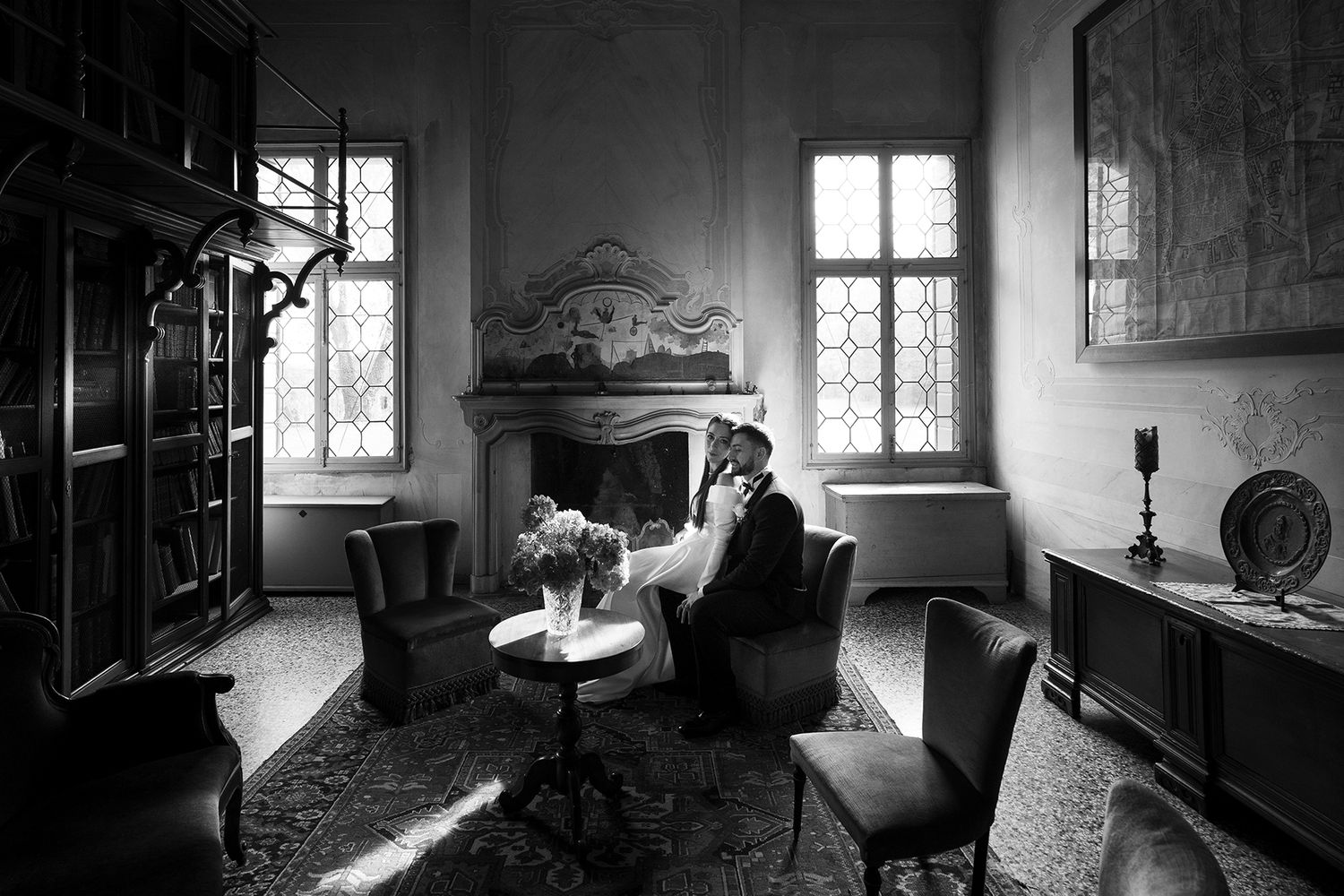 Moody black and white interior shots of a rustic room with dramatic window lighting.