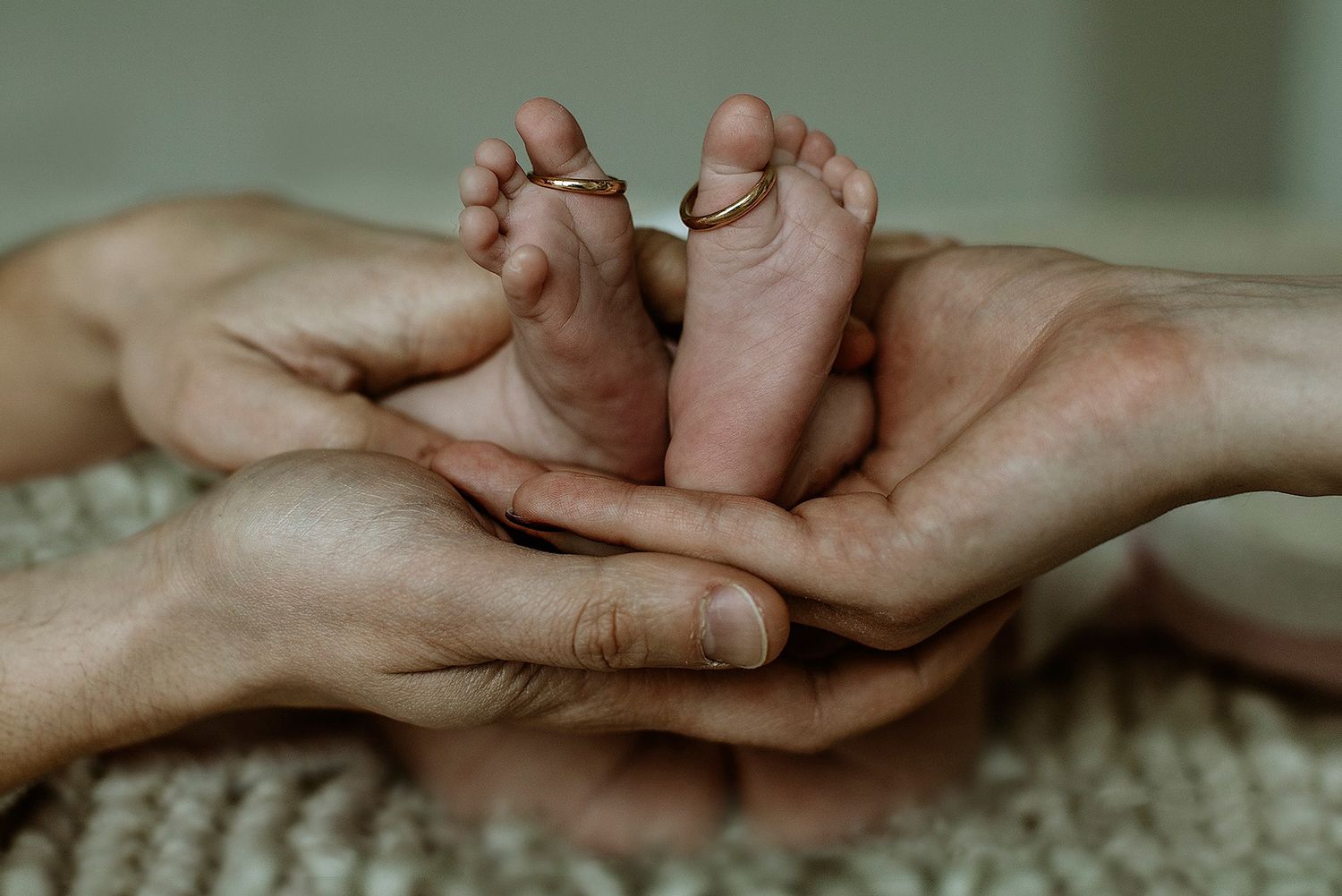 Close-up of hands tenderly touching on textured fabric surface.