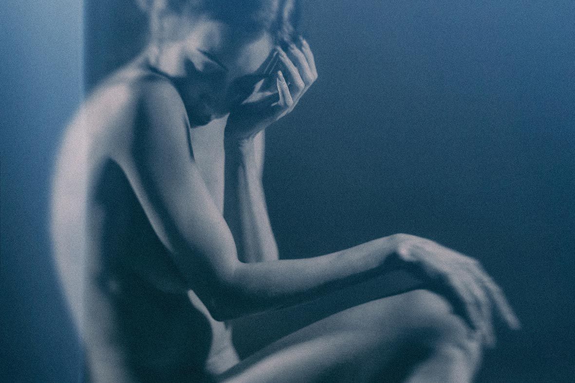 Moody blue-tinted portrait sequence capturing graceful motion and dramatic lighting.