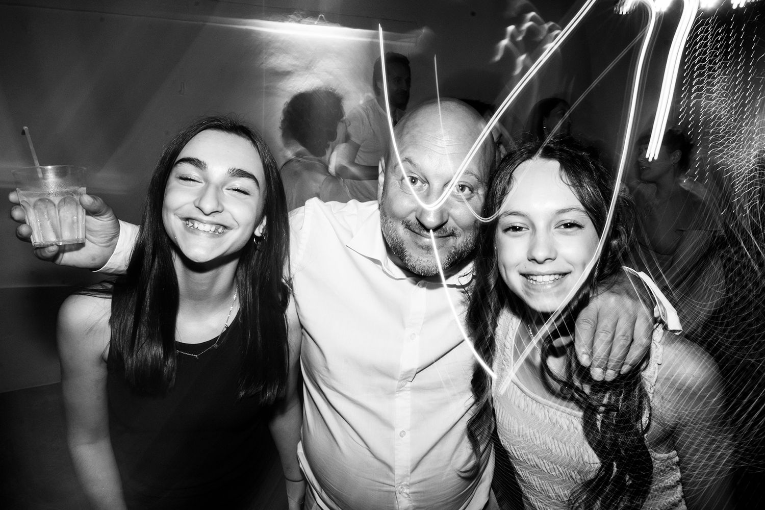 Series of candid black and white shots capturing joyful party moments.