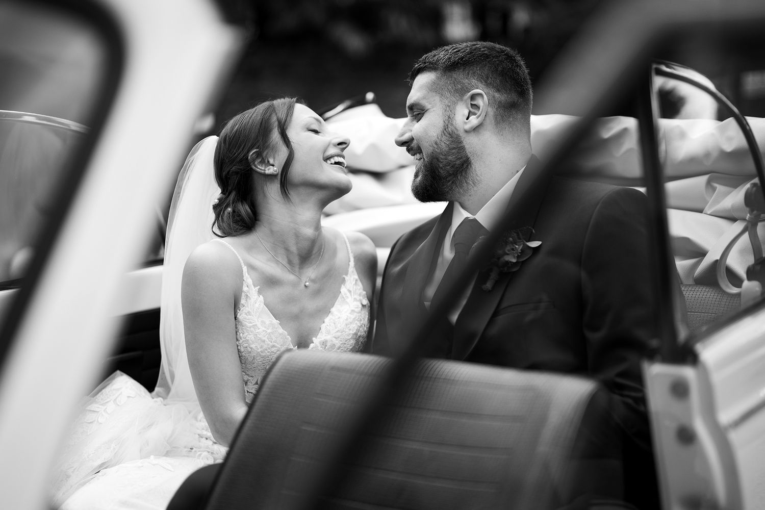 Close-up black and white wedding photography capturing intimate moments through creative framing.