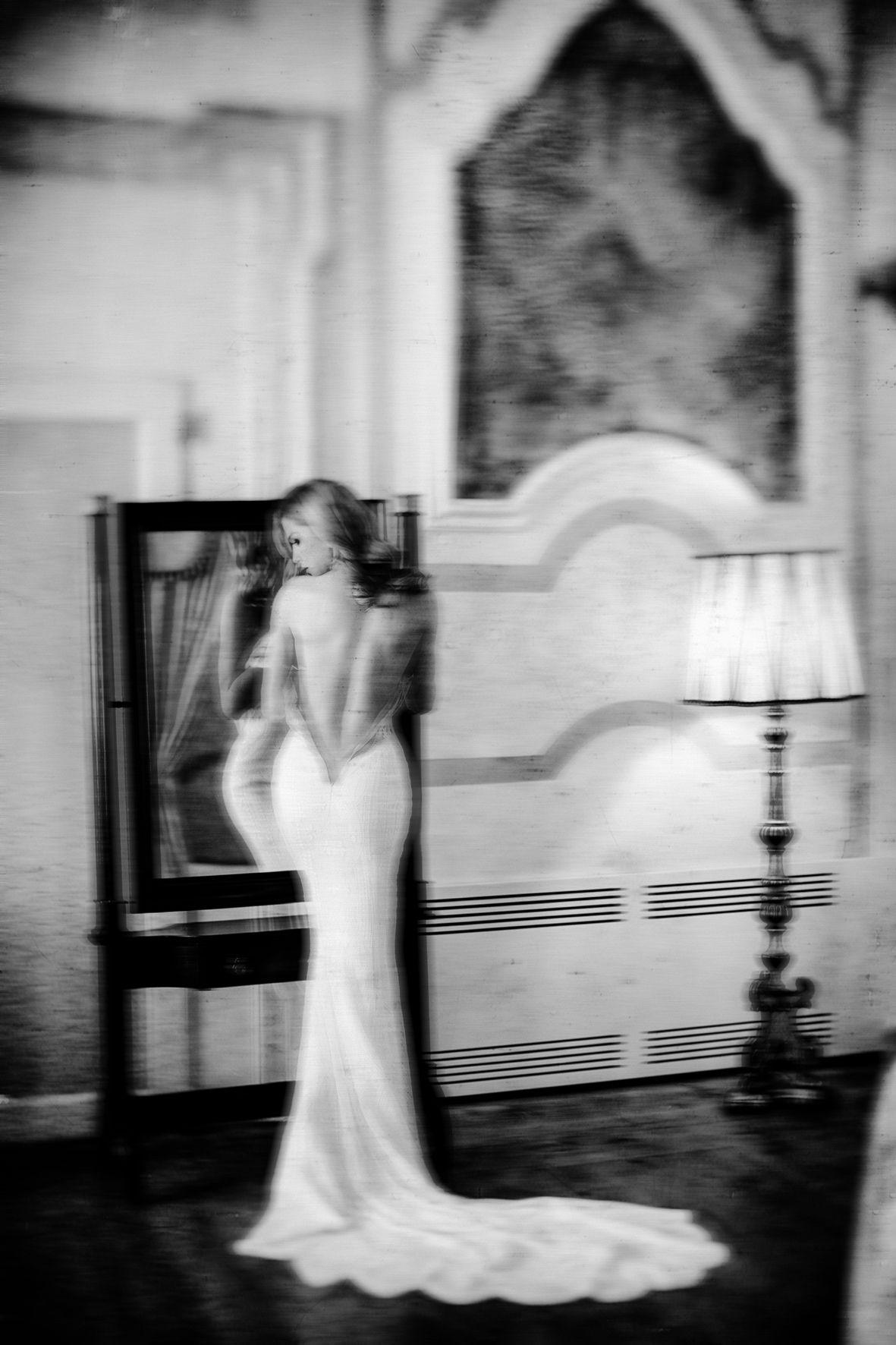 A series of black and white photographs showing a ghostly figure in a white dress moving through a dimly lit hallway.
