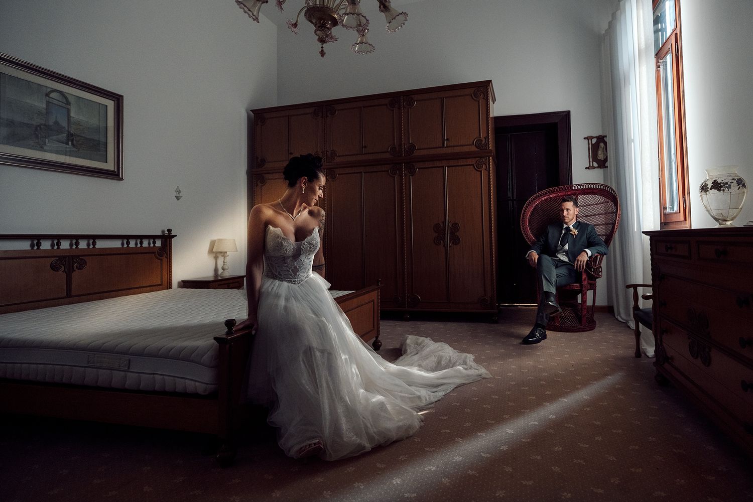 Panoramic wedding photography in dark wood-paneled room with dramatic lighting.