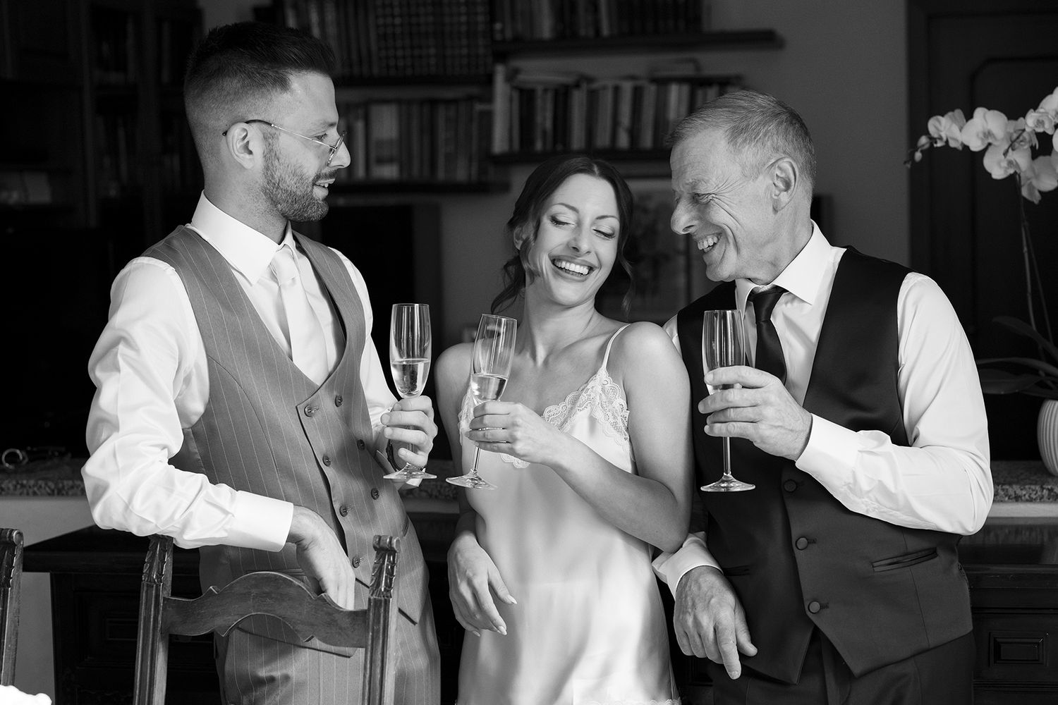 Group toasting with champagne glasses at elegant indoor celebration.
