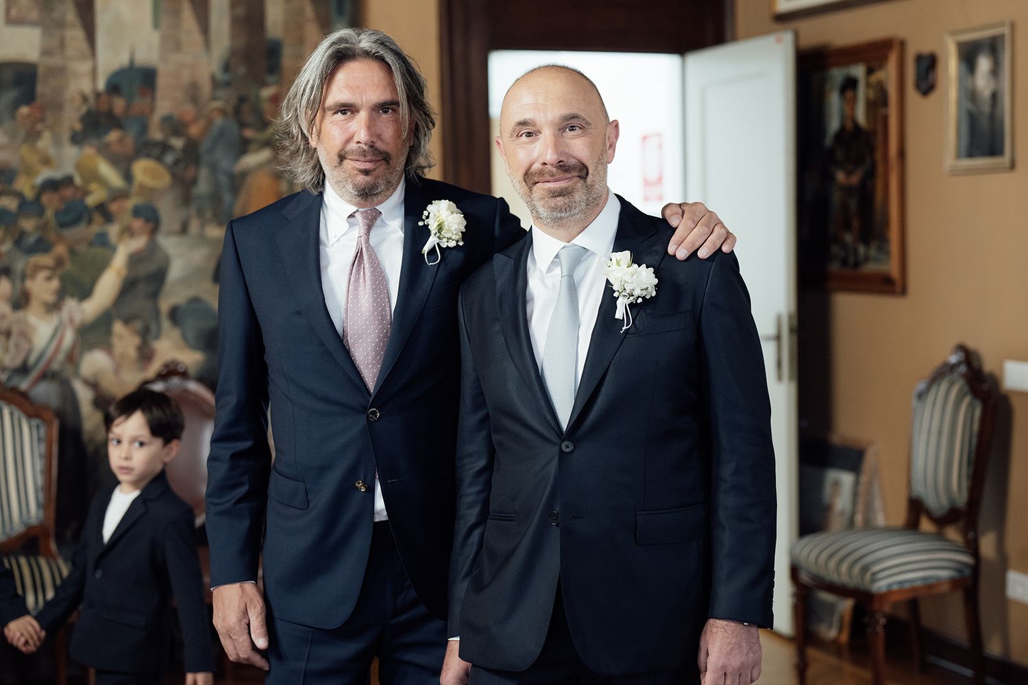 Wedding party members in formal attire posing together.