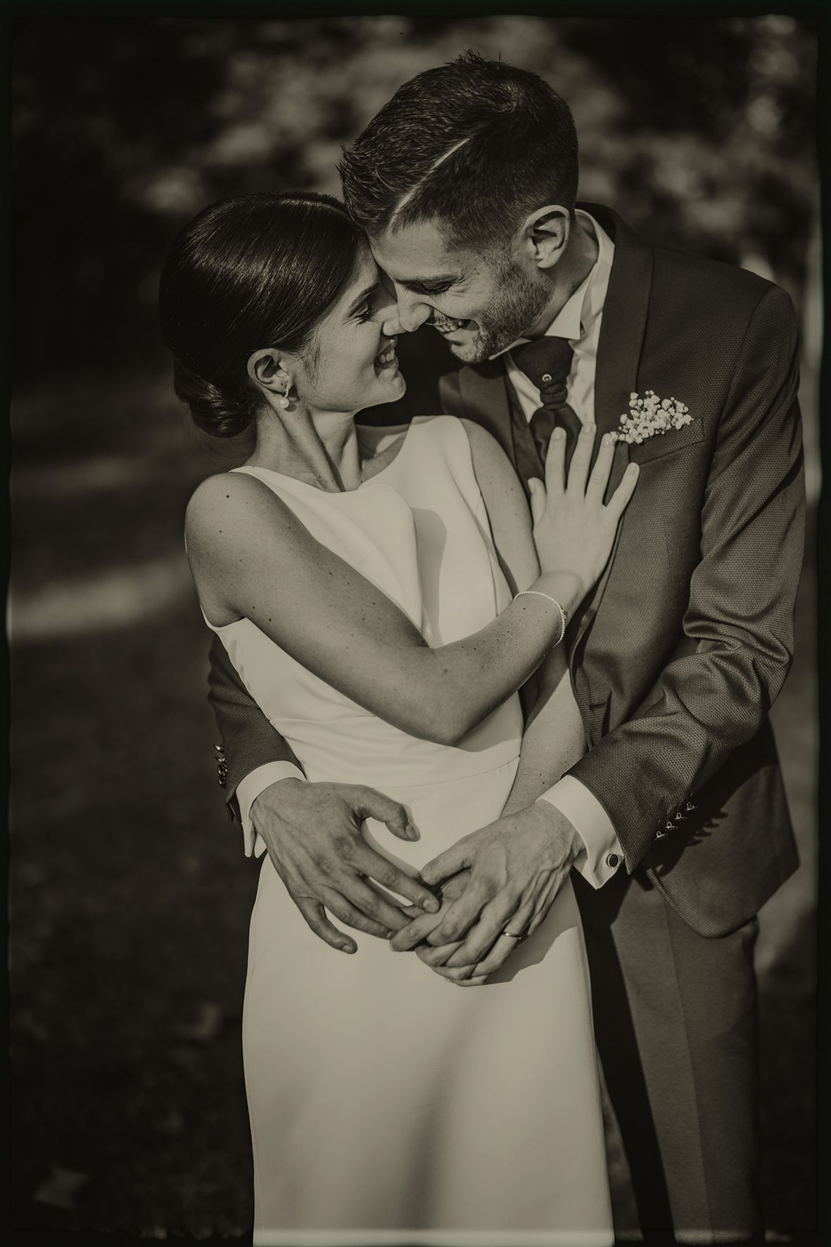 A romantic black and white photo sequence of a couple sharing tender kisses and embraces during their wedding day.