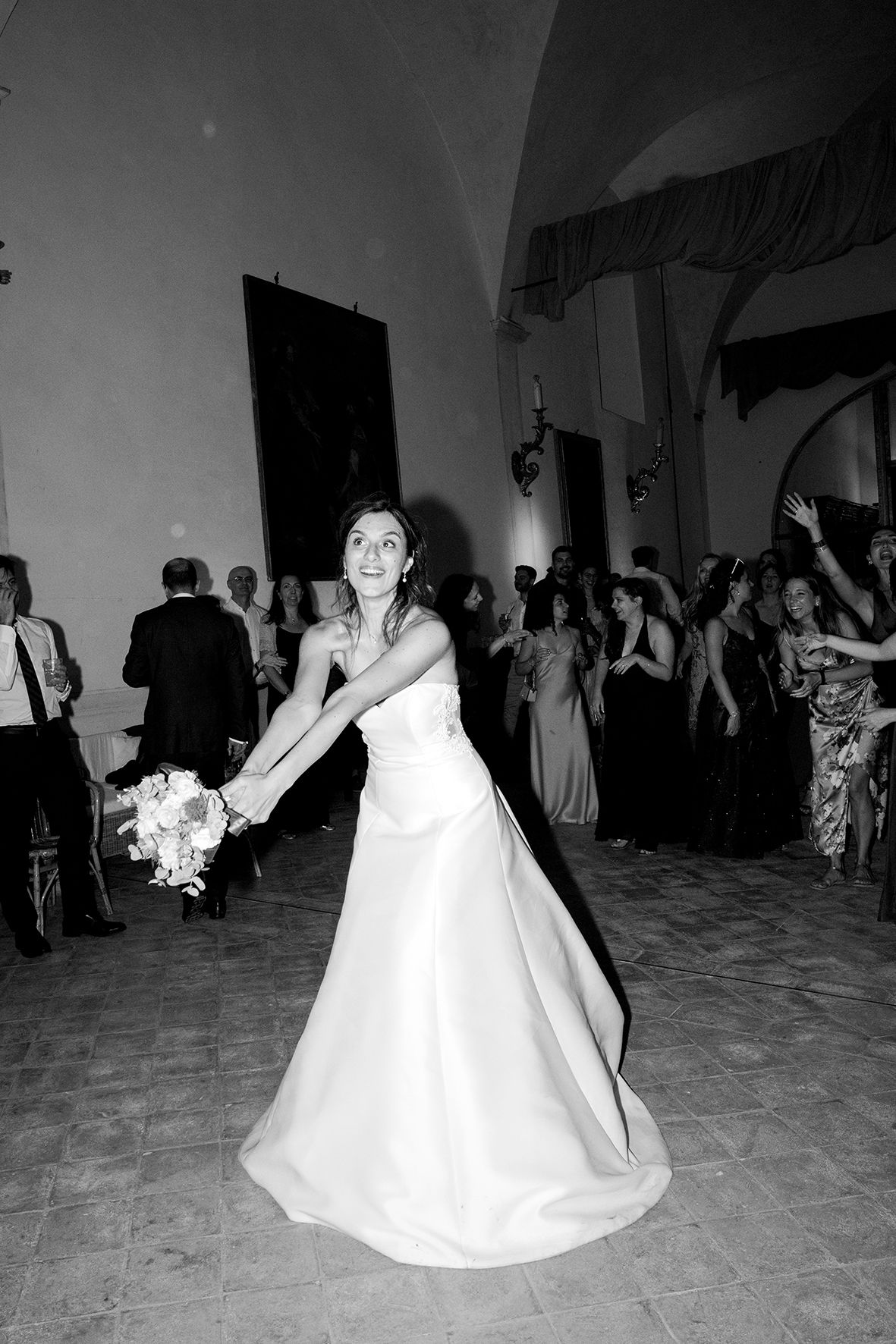 Black and white photos of people dancing at a wedding reception on a large dance floor.