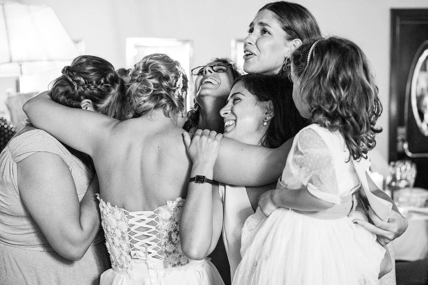 Romantic wedding moments showing couples sharing intimate kisses in black and white photography.