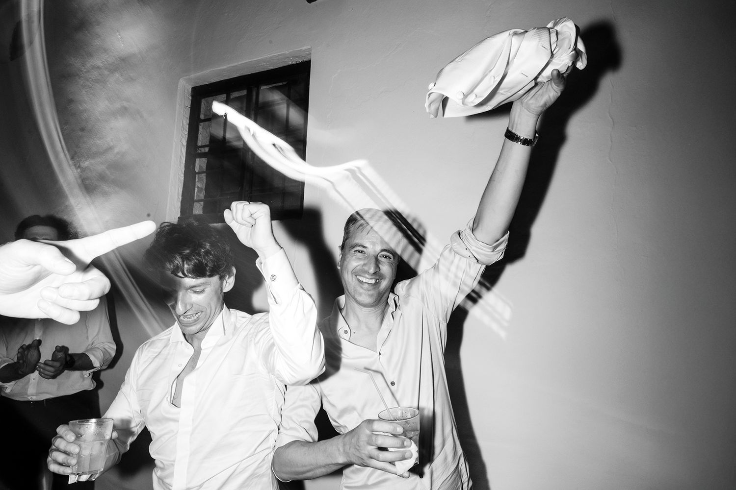 Black and white party snapshots showing animated celebration moments.