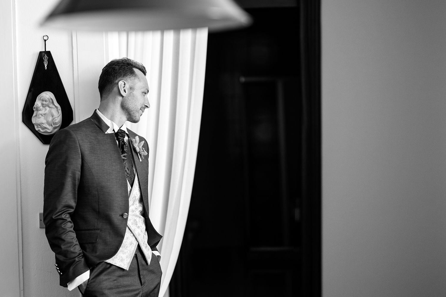 Dramatic black and white wedding portraits with strong contrast and shadows.