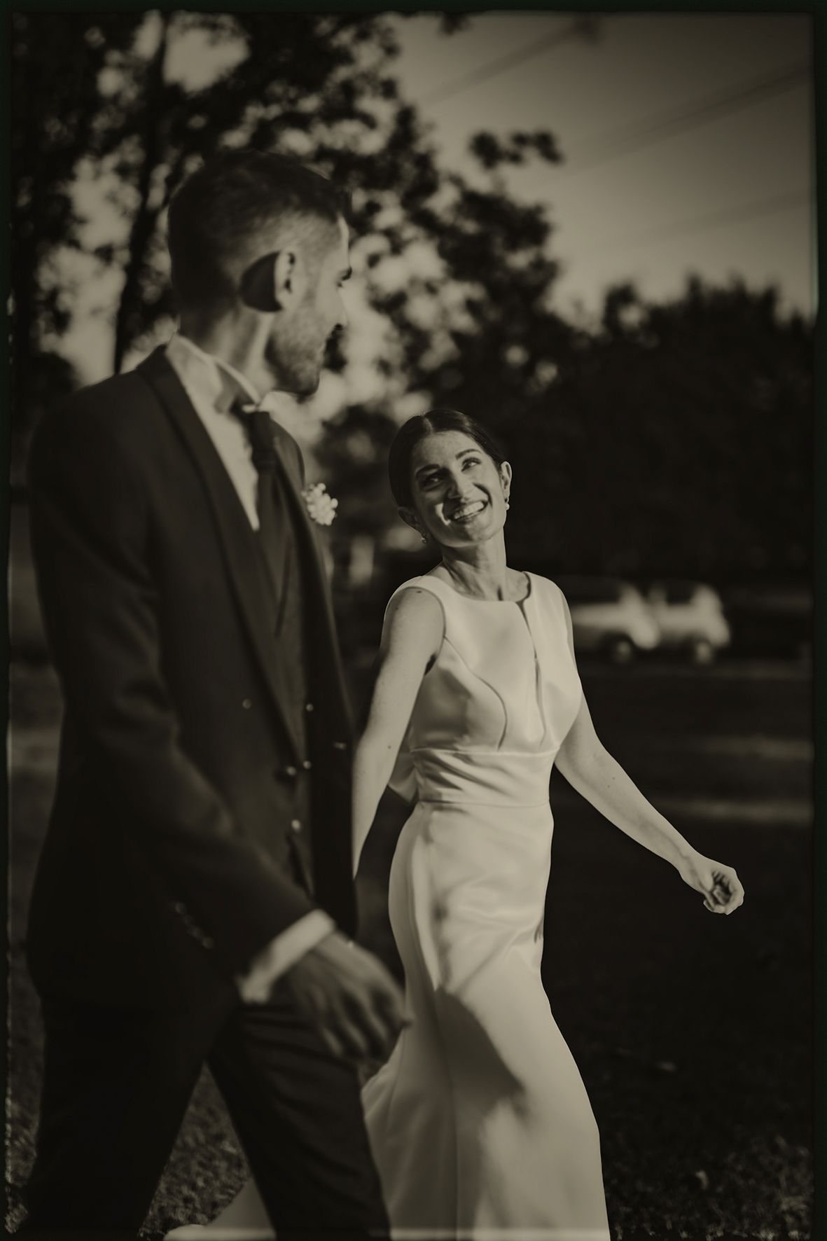 Black and white wedding photos show a couple sharing intimate moments outdoors in a romantic garden setting.