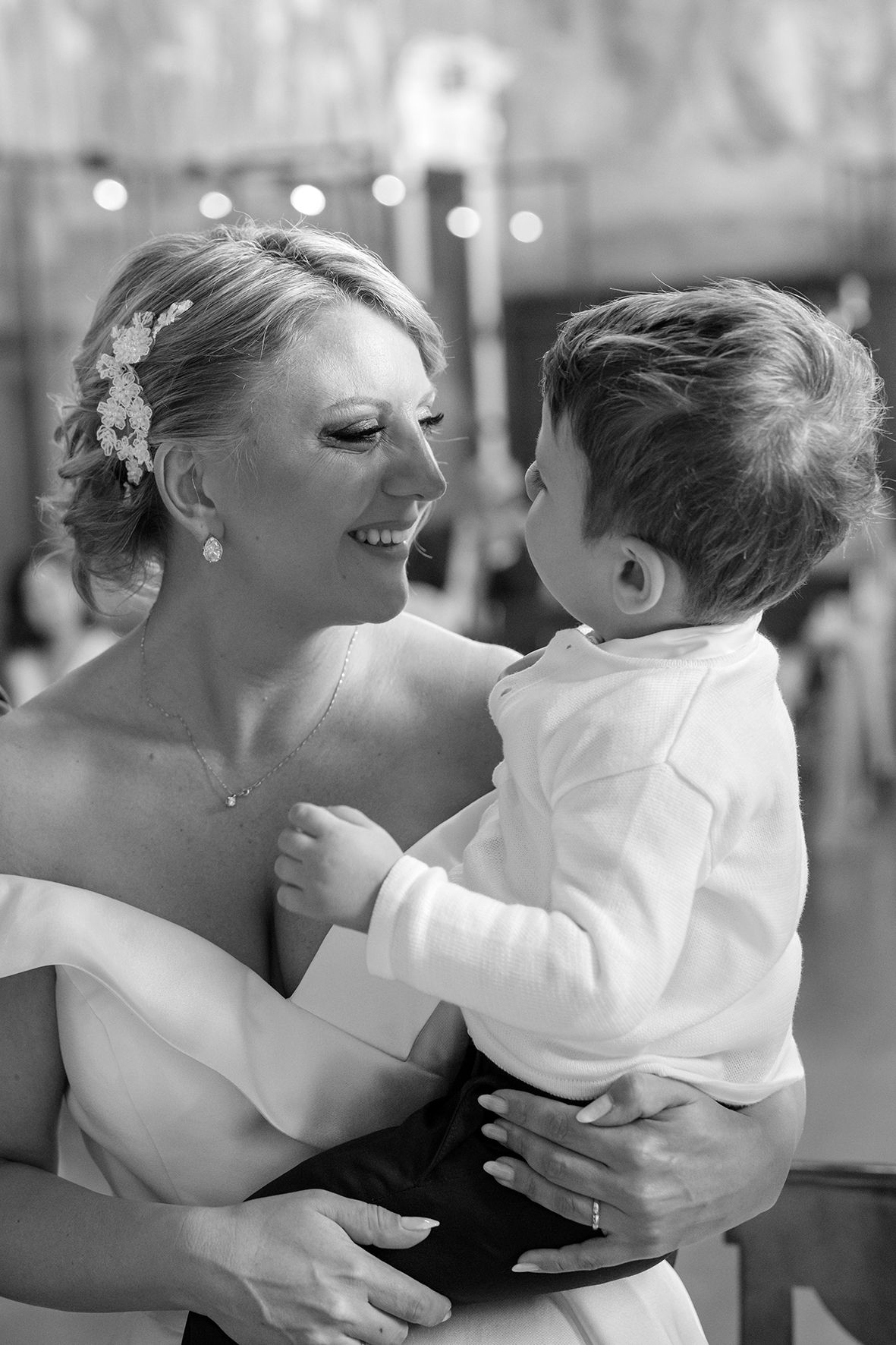 Black and white sequence capturing joyful embraces at a wedding celebration.