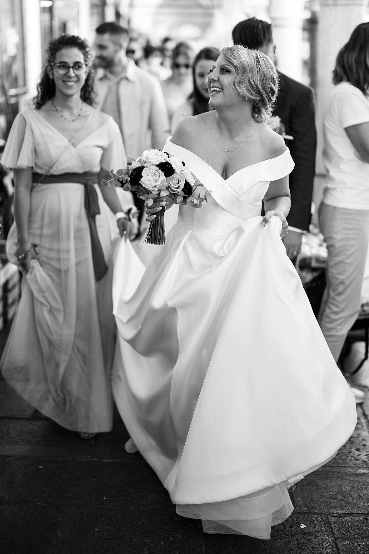 Joyful dancing and celebration in white dresses at an elegant wedding reception.