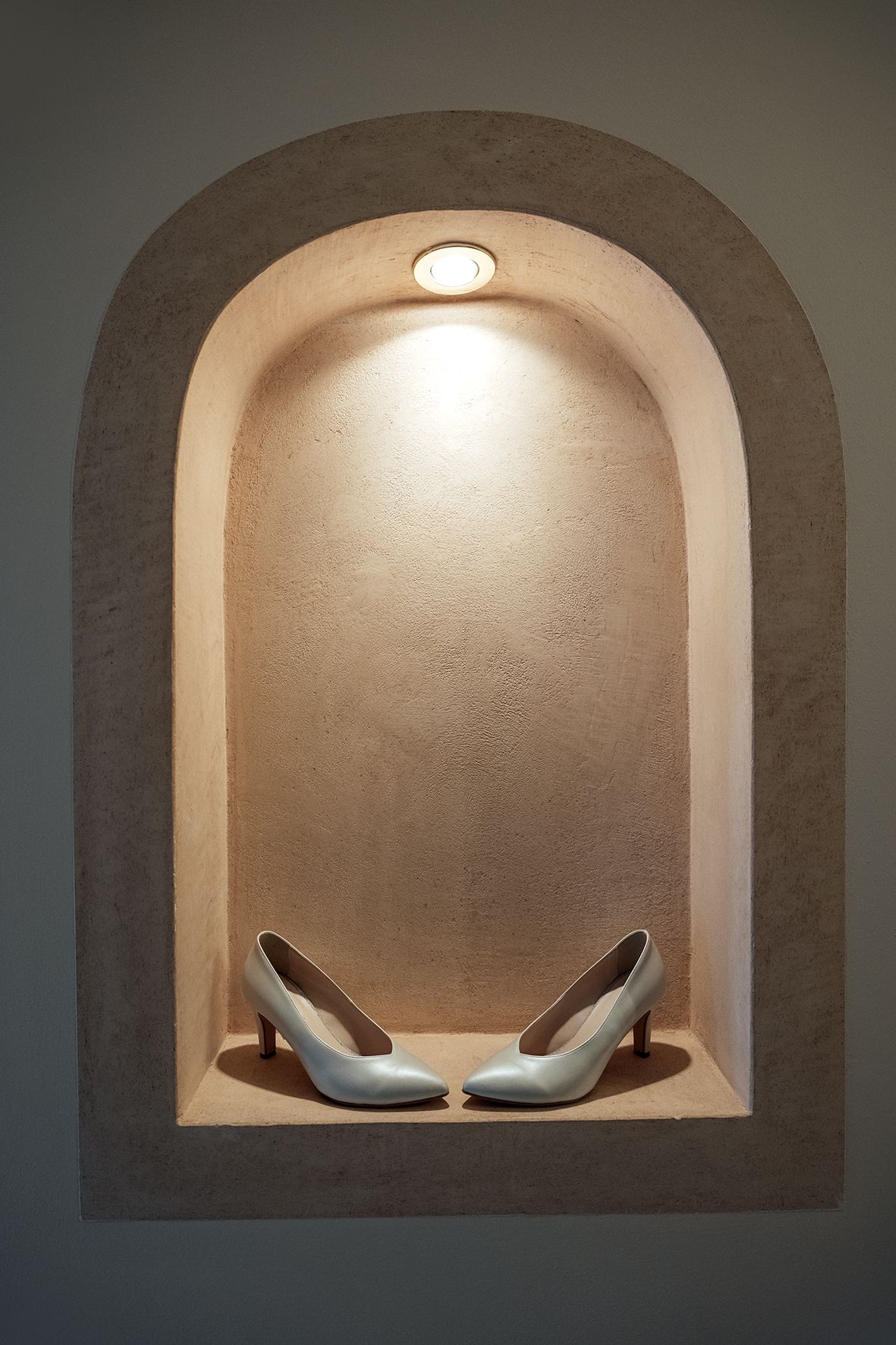 Minimalist architectural detail of curved alcove with subtle lighting and modern seating.