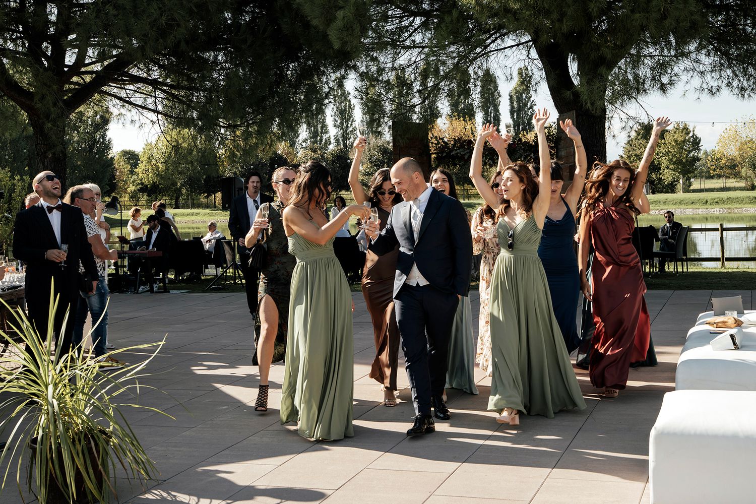 Wedding celebration with guests mingling on an outdoor patio.